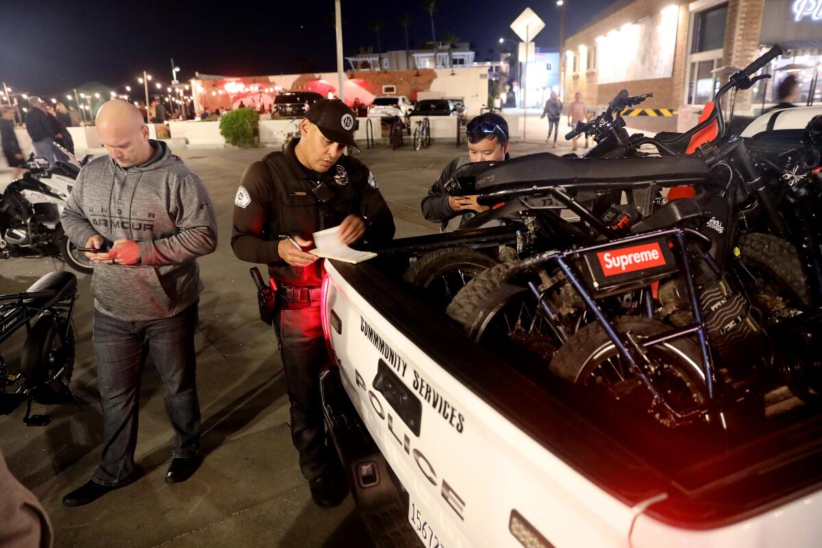 Hermosa Beach Police write citations for four juveniles for riding their e-bikes along the Strand in Hermosa Beach.