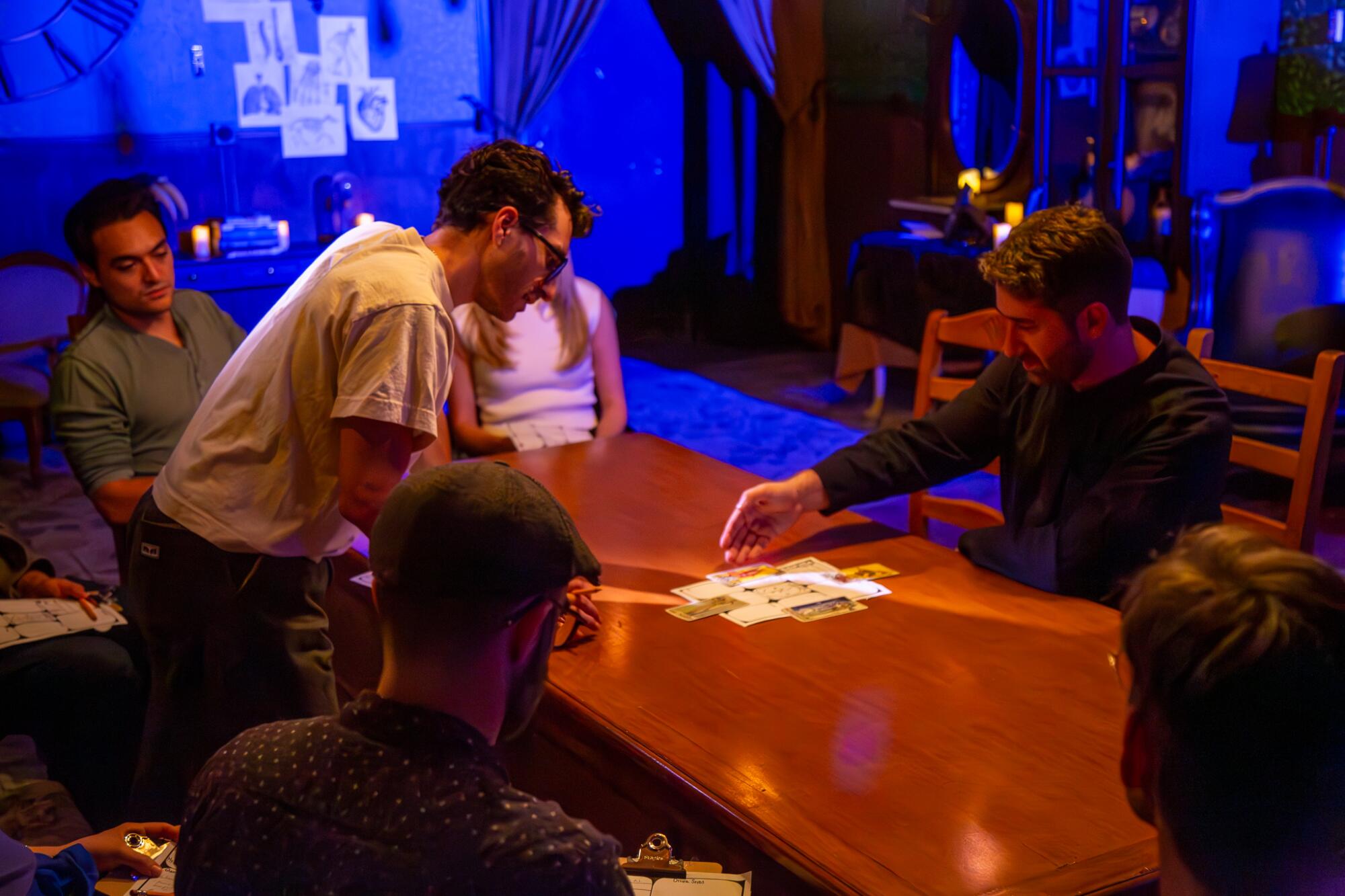 A group gathered around a tarot reader. 