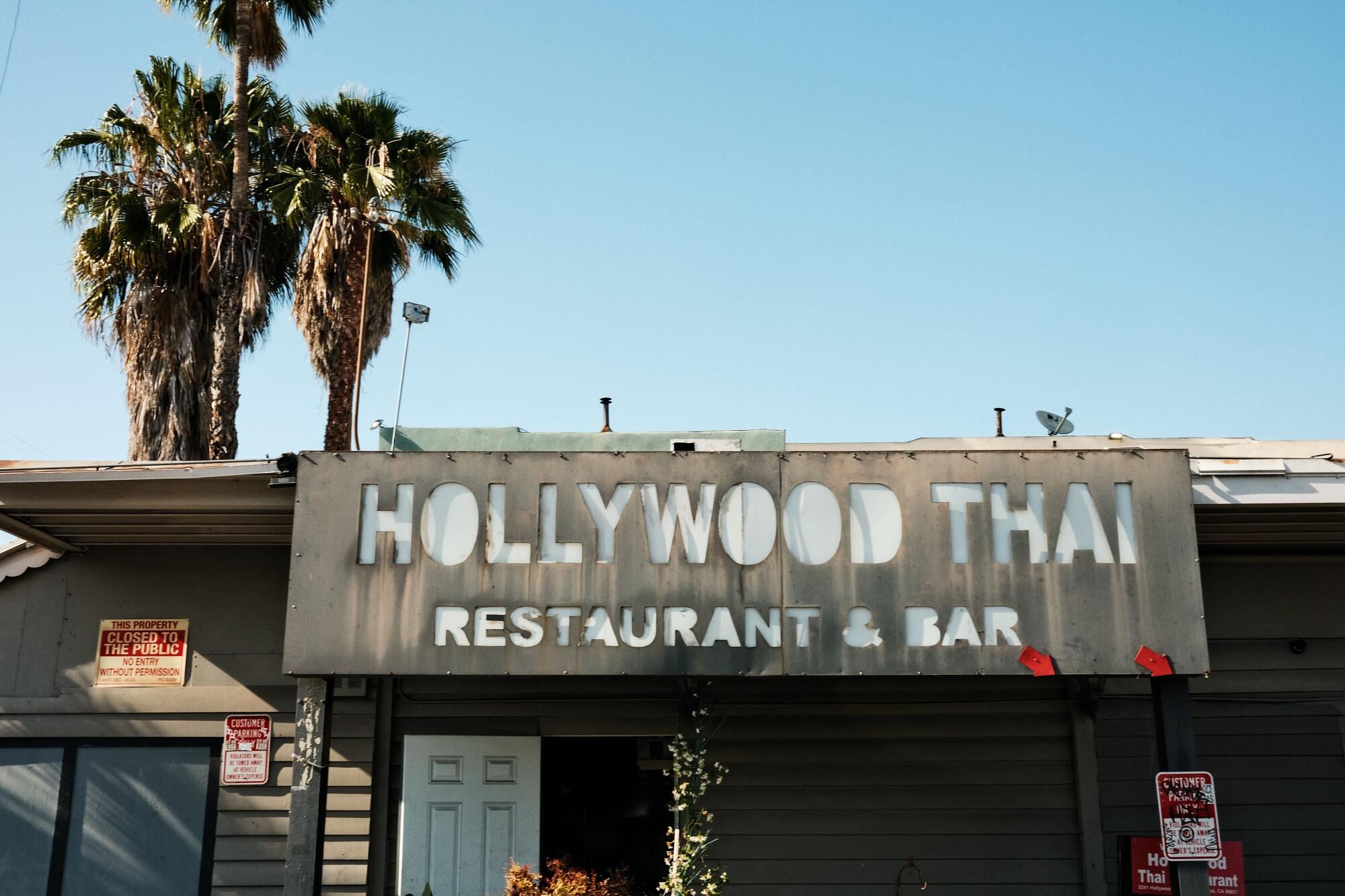 An exterior of Hollywood Thai. Behind is a palm tree