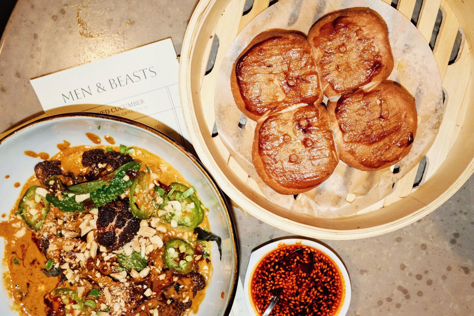Curried cauliflower with steamed buns, house chile oil and a menu at plant-based Chinese restaurant Men & Beasts in Echo Park