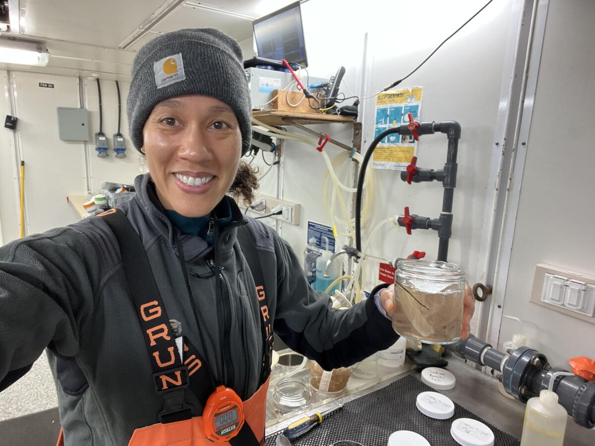 Noelle Bowlin takes a selfie just after preserving an ocean surface sample collected with a manta net.
