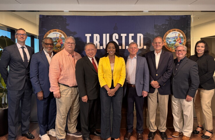 California State Controller Malia Cohen at the center of a photo lineup of nine people