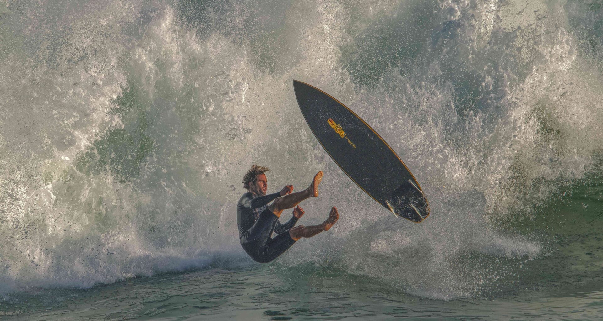 A surfer drops in to a massive break at The Wedge