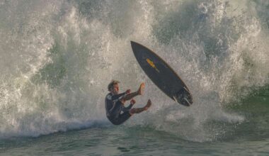 A surfer drops in to a massive break at The Wedge