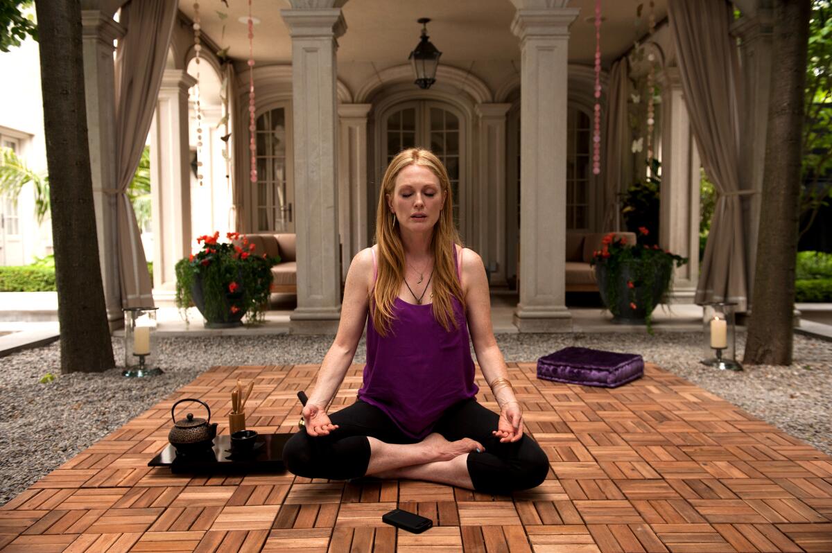 A woman sits in a yoga pose.