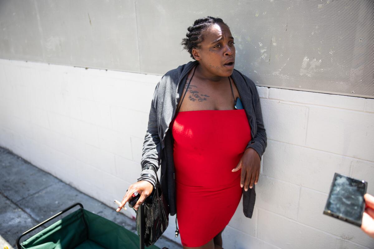 Martika Johnson-Rogers, wearing a red dress
