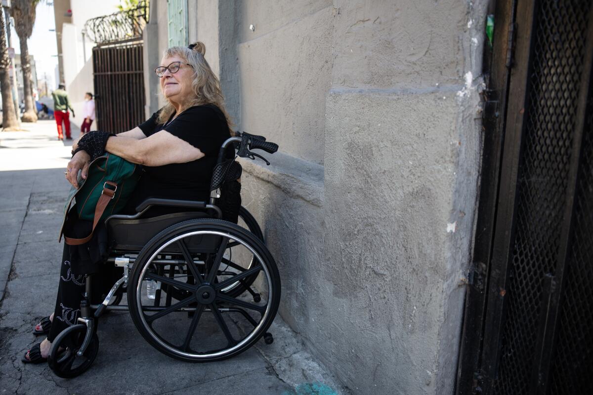 Michele Brewster, sitting in a wheelchair
