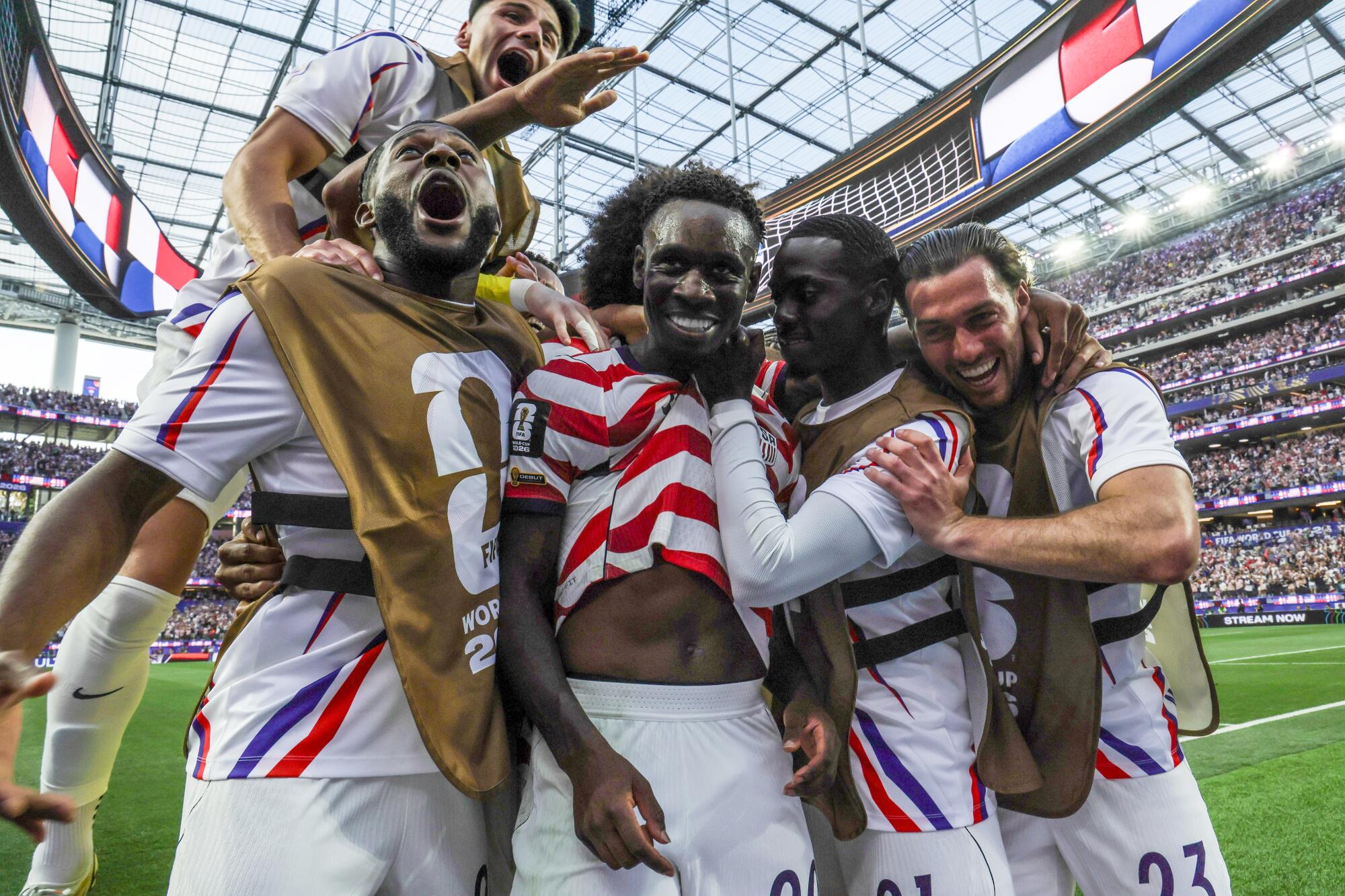 U.S. striker Folarin Balogun, center, celebrates with teammates after scoring his second goal.