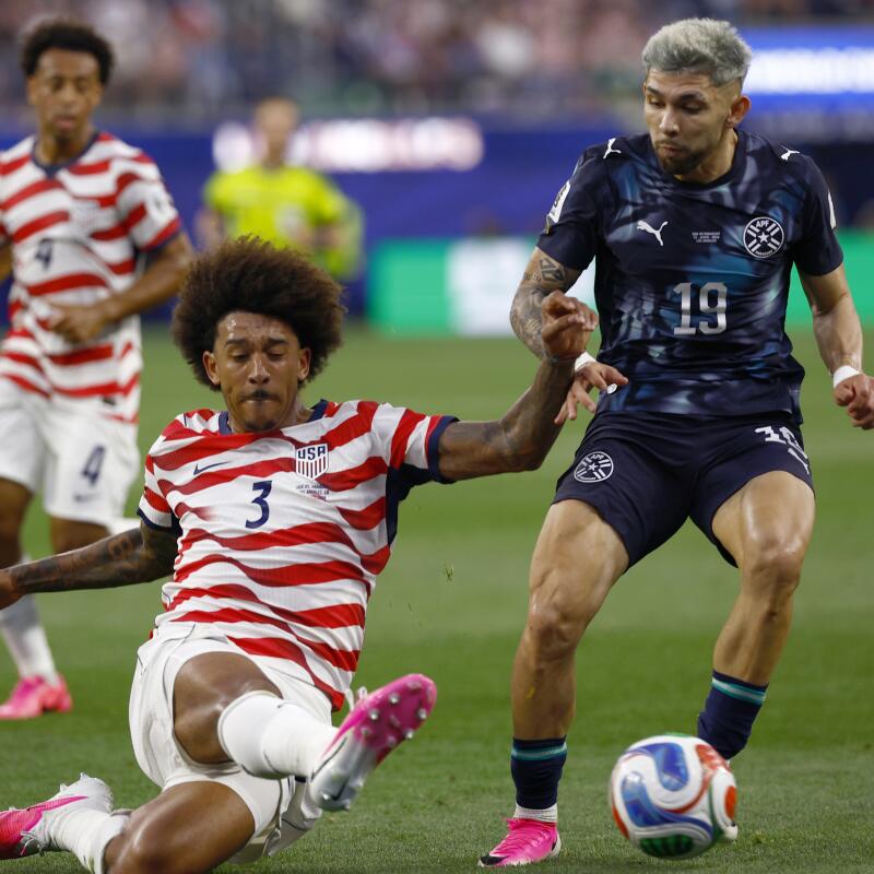 U.S. defender Chris Richards, left, slides to kick the ball away from Paraguay forward Julio Enciso in the second half.