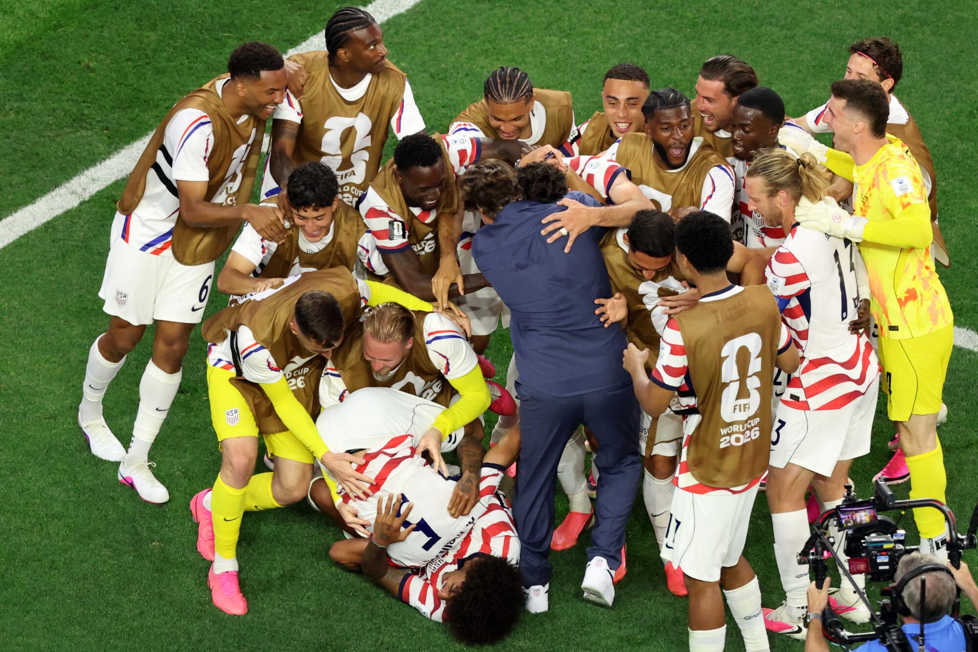 United States Men's Soccer Team head coach Mauricio Pochettino, center, celebrates with his team.