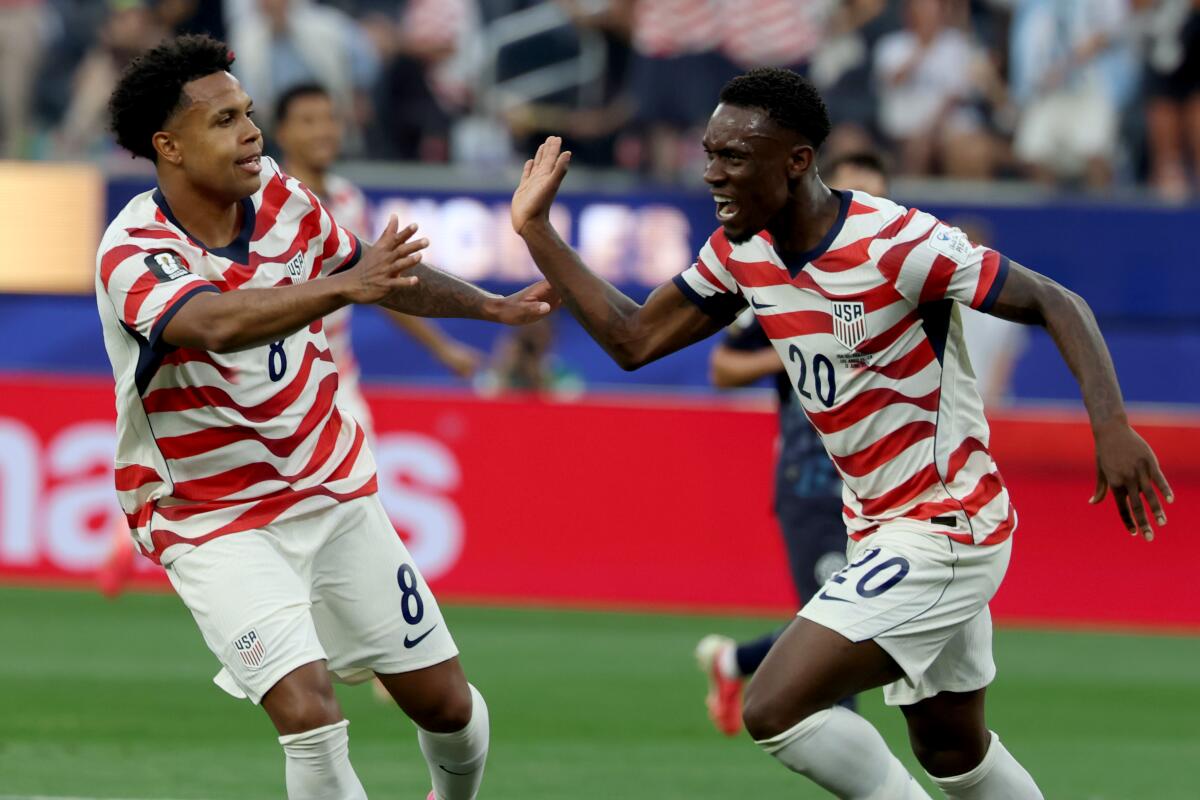 U.S. striker Folarin Balogun, right, celebrates with Weston McKennie after scoring in the first half.