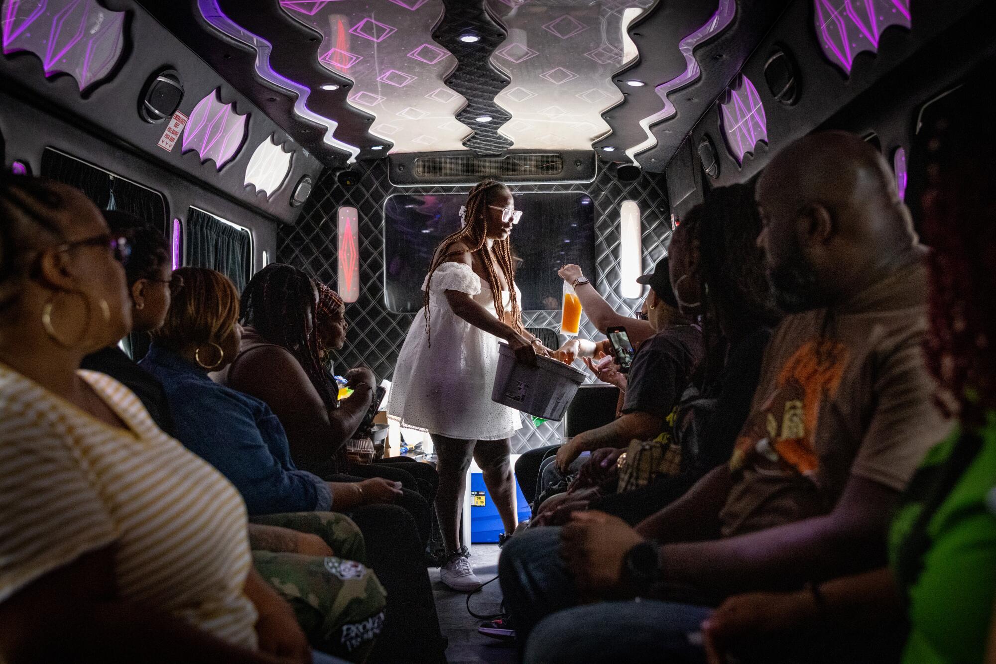 Host Daisy Miles kicks off her party bus tour by passing out mixed drinks in Capri-style pouches.