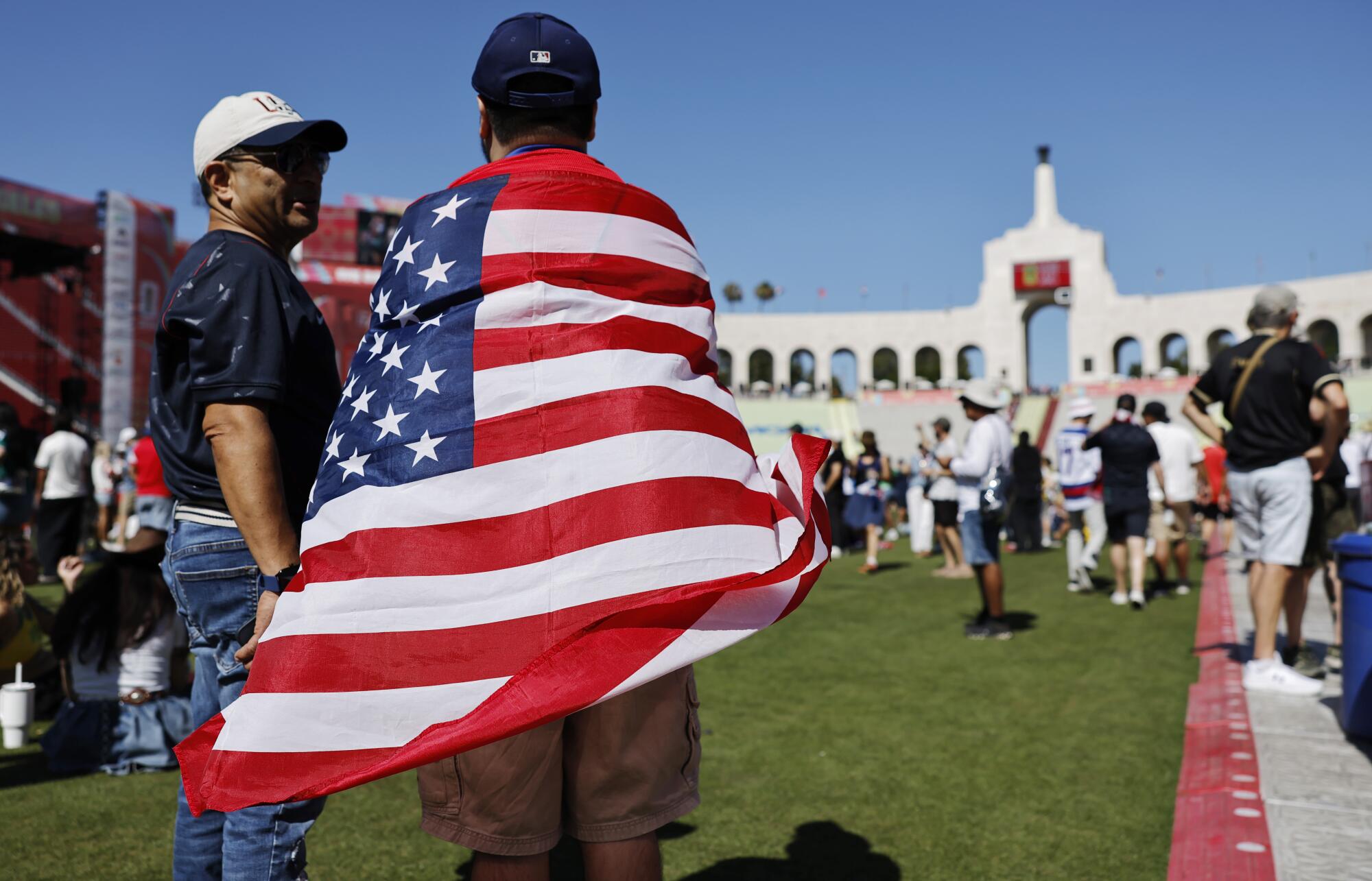 A fan wears an American flag during a U.S. World Cup watch party at the Coliseum on Friday.