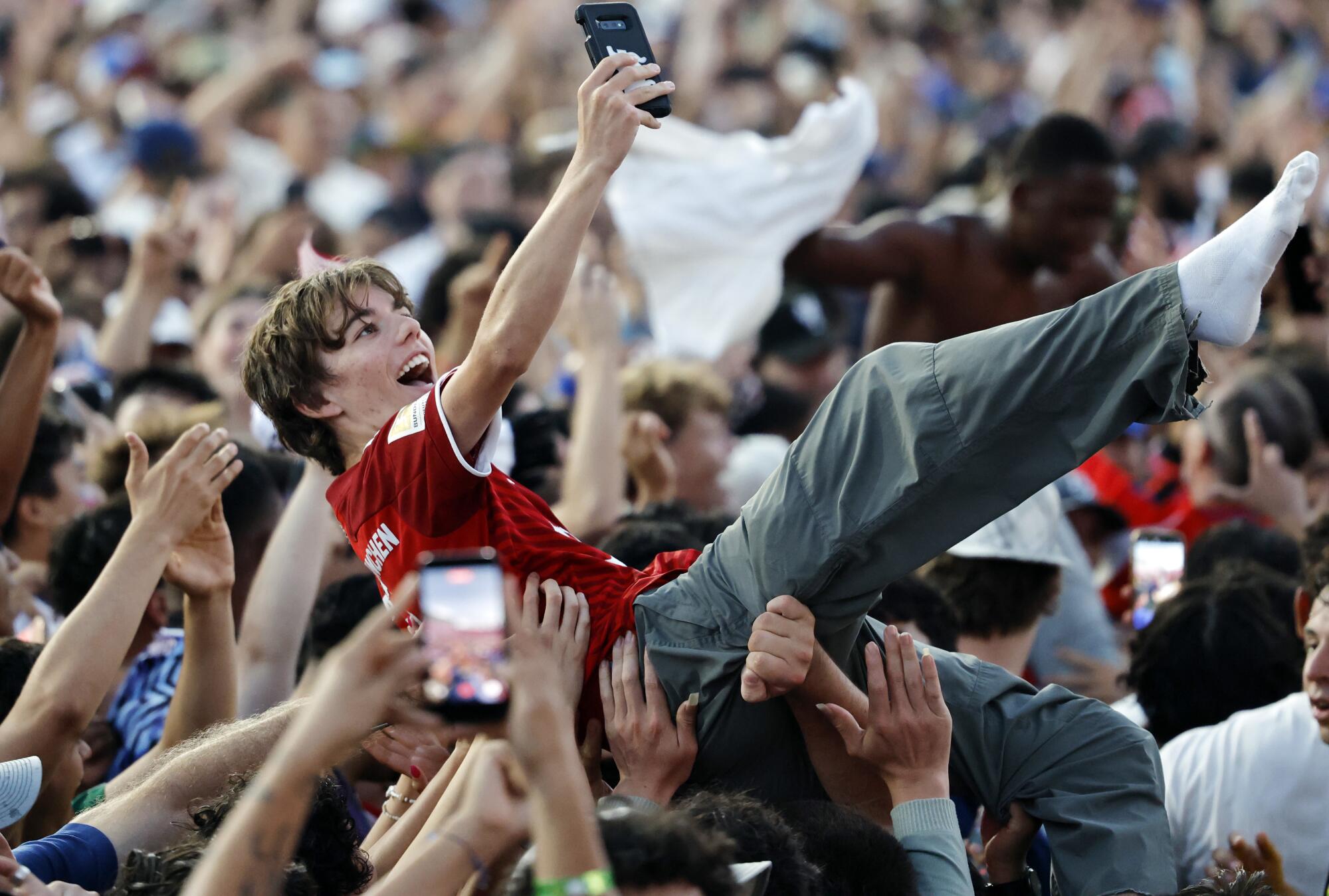 U.S. fans celebrate during a watch party at the Coliseum as Americans beat Paraguay during the World Cup Friday.