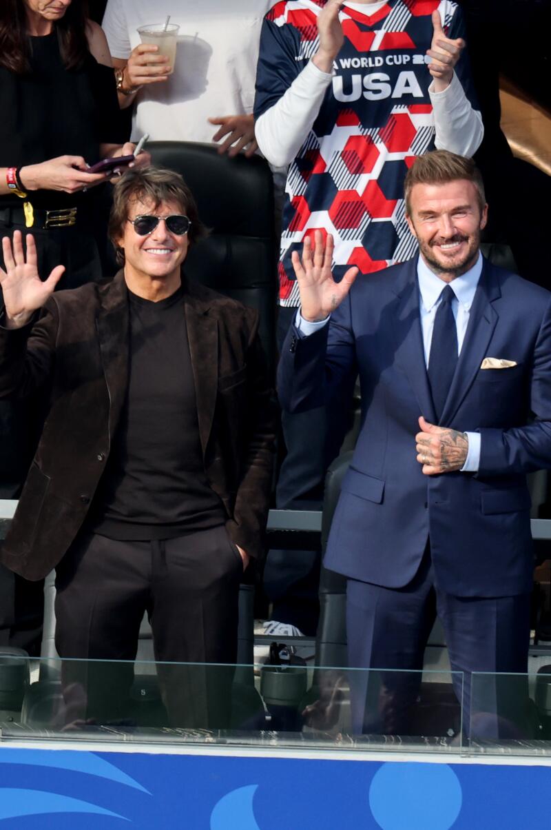 Sir David Beckham and Tom Cruise waves to fans.