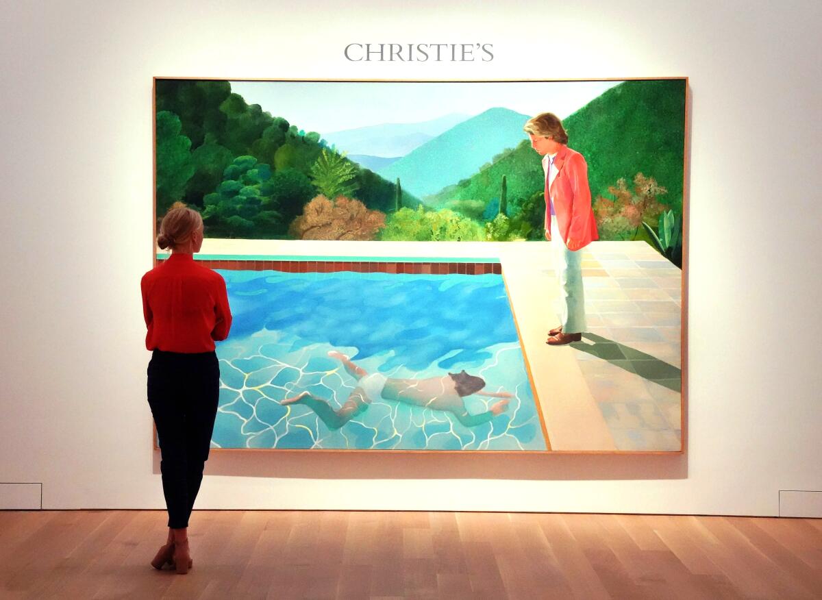 A woman gazes at a painting.