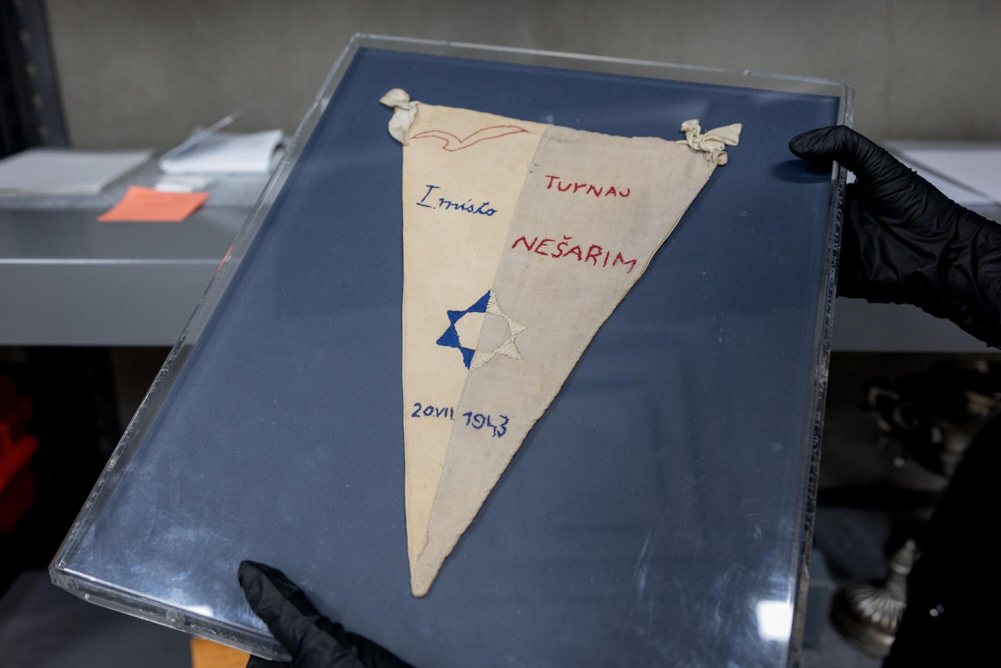 The soccer team at the Theresienstadt concentration camp's flag is displayed in a Holocaust Museum LA exhibit.