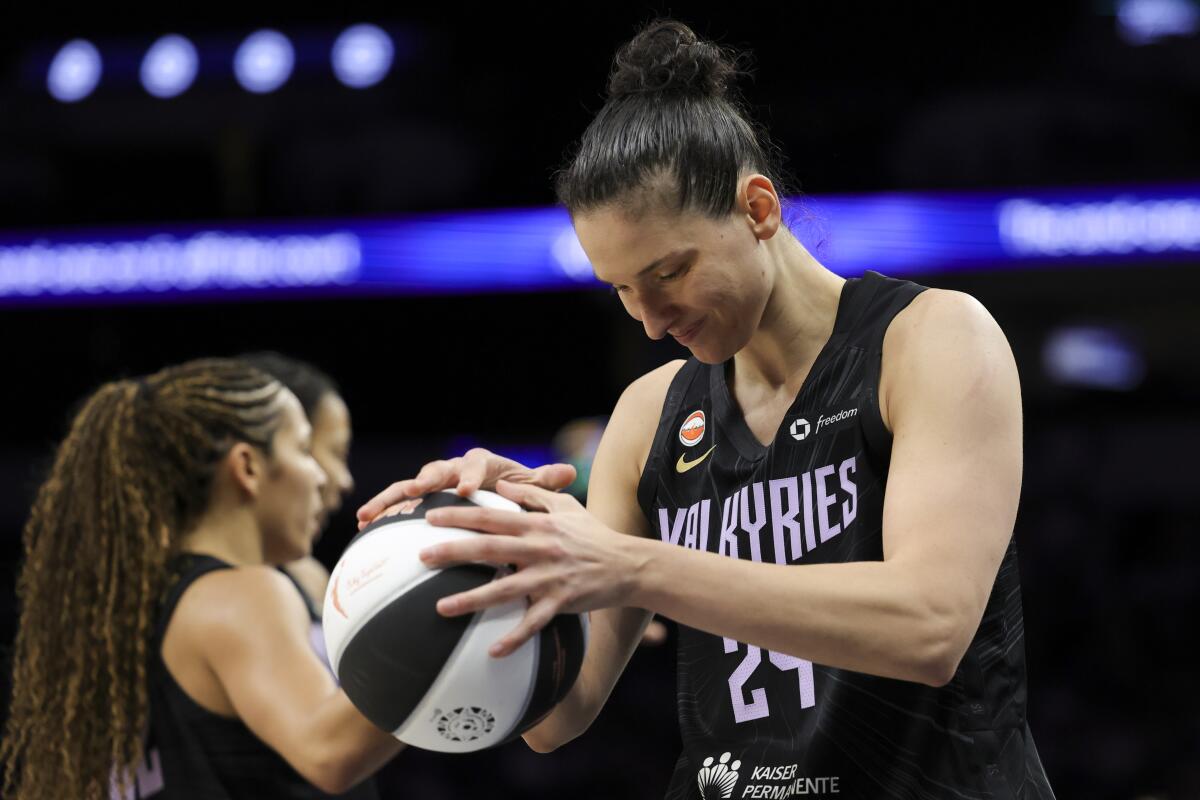 Valkyries forward Cecilia Zandalasini grabs a basketball with two hands during a break in play.