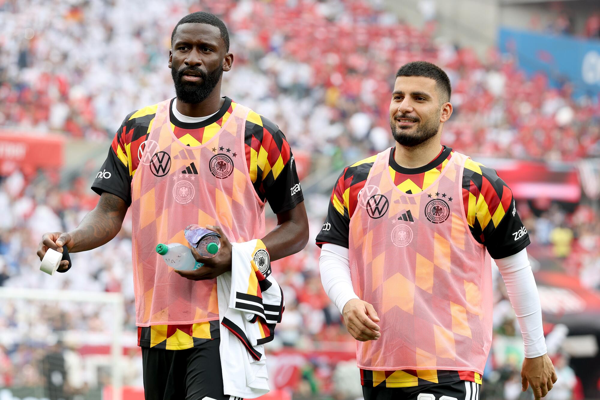 Germany's Antonio Rudiger and Deniz Undav walk on the field before a friendly match against the U.S.