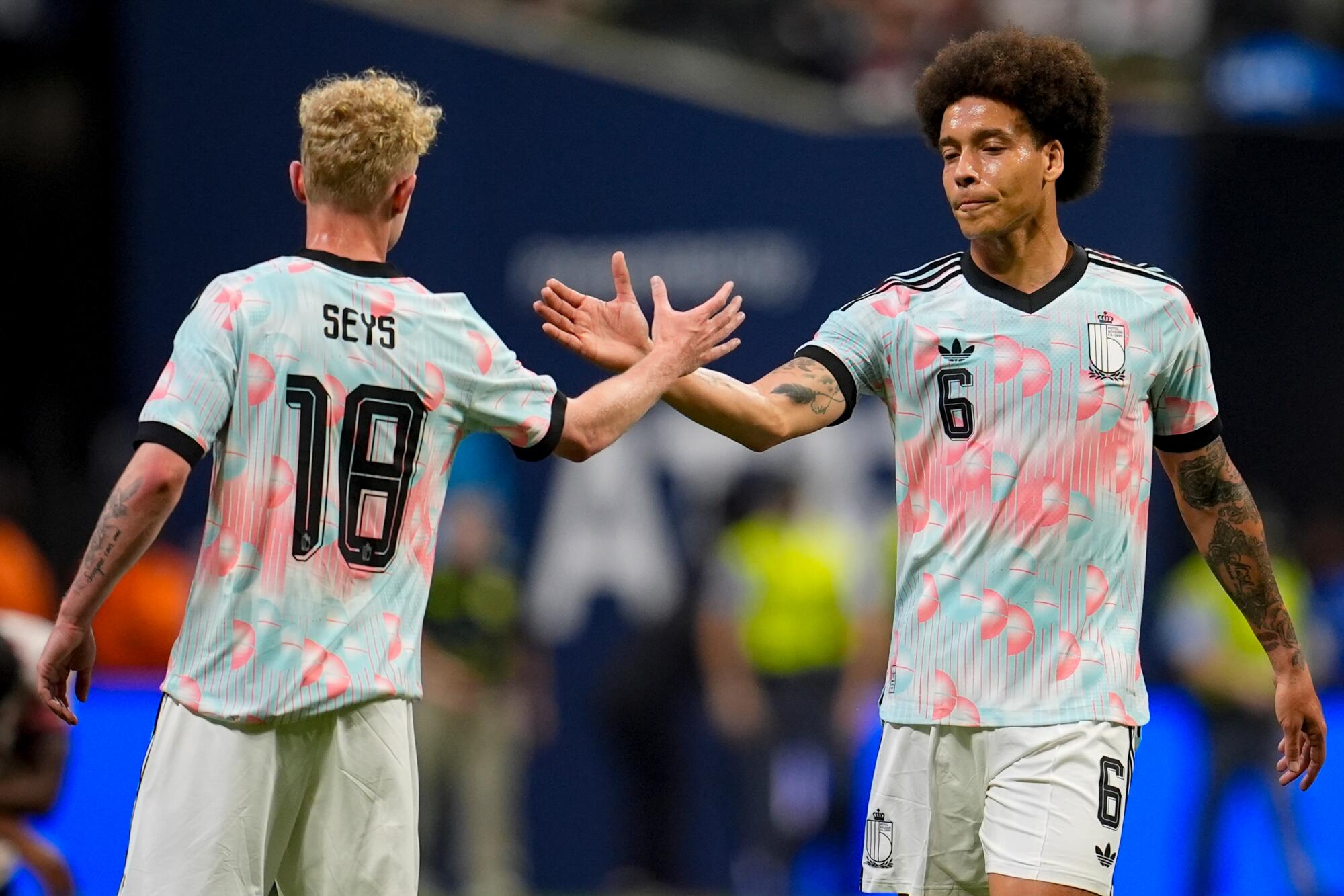 Belgium's Joaquin Seys, left, and Axel Witsel celebrate after defeating the U.S. in an international friendly on March 28.