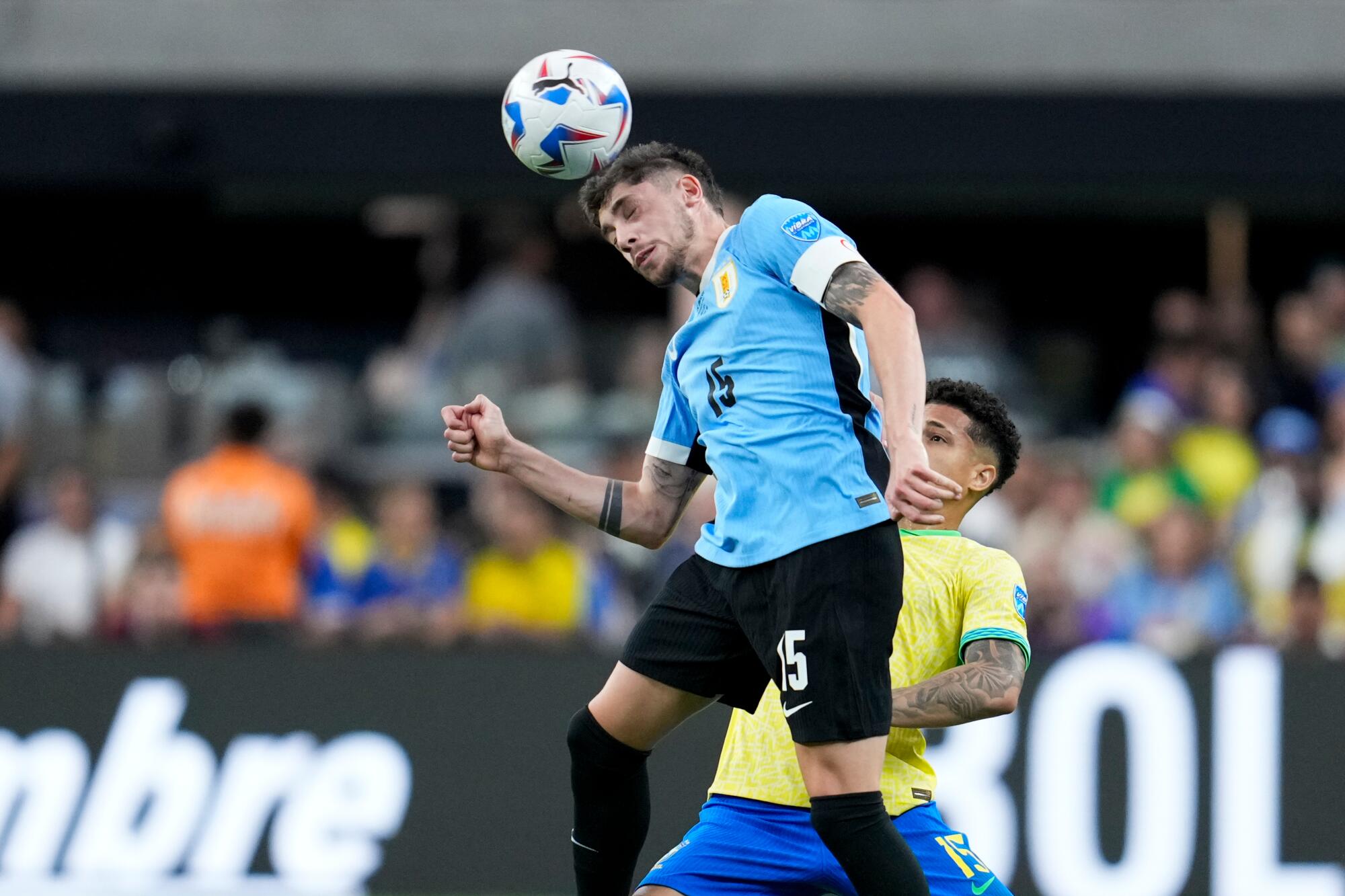 Uruguay's Federico Valverde heads the ball past Brazil's Joao Gomes during a Copa America quarterfinal match in 2024.