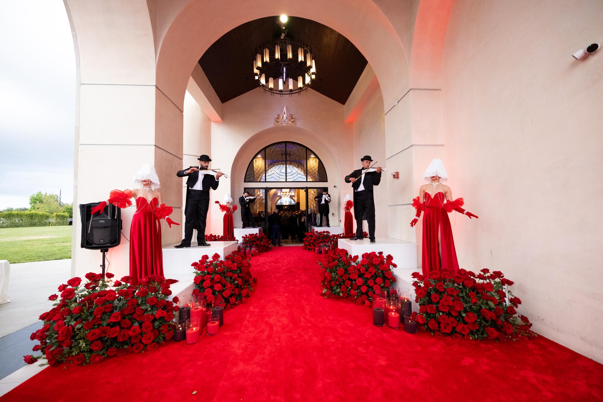 The red carpet entrance to a wedding party at the Landmark Venue in Mission Hills, with violin players.