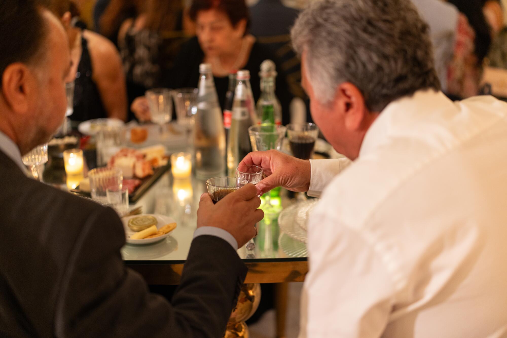 Guests toast at a wedding at the Landmark Venue in Mission Hills.