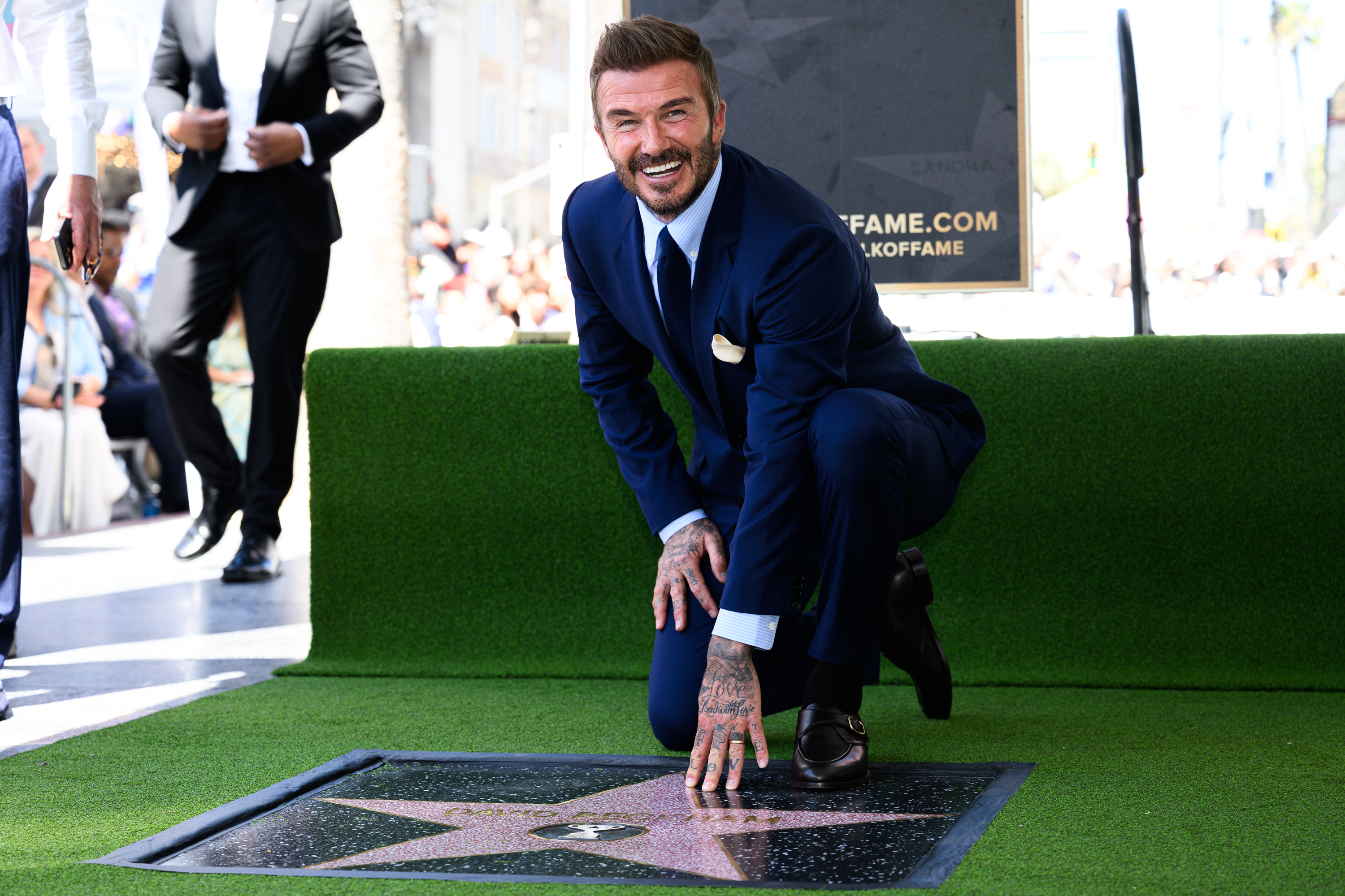 David Beckham poses with his new star on the Hollywood...