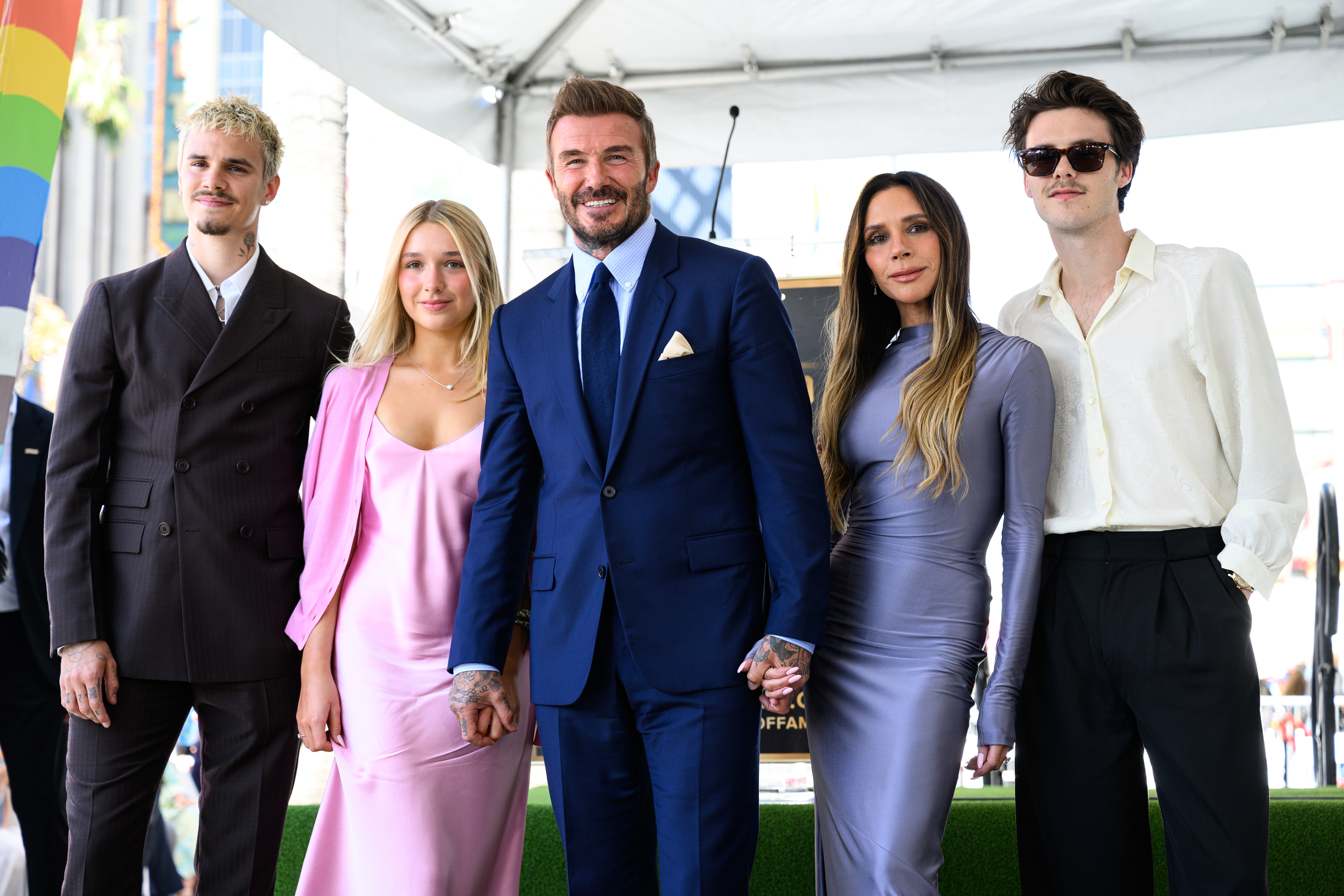 David Beckham poses with his wife Victoria and their children...