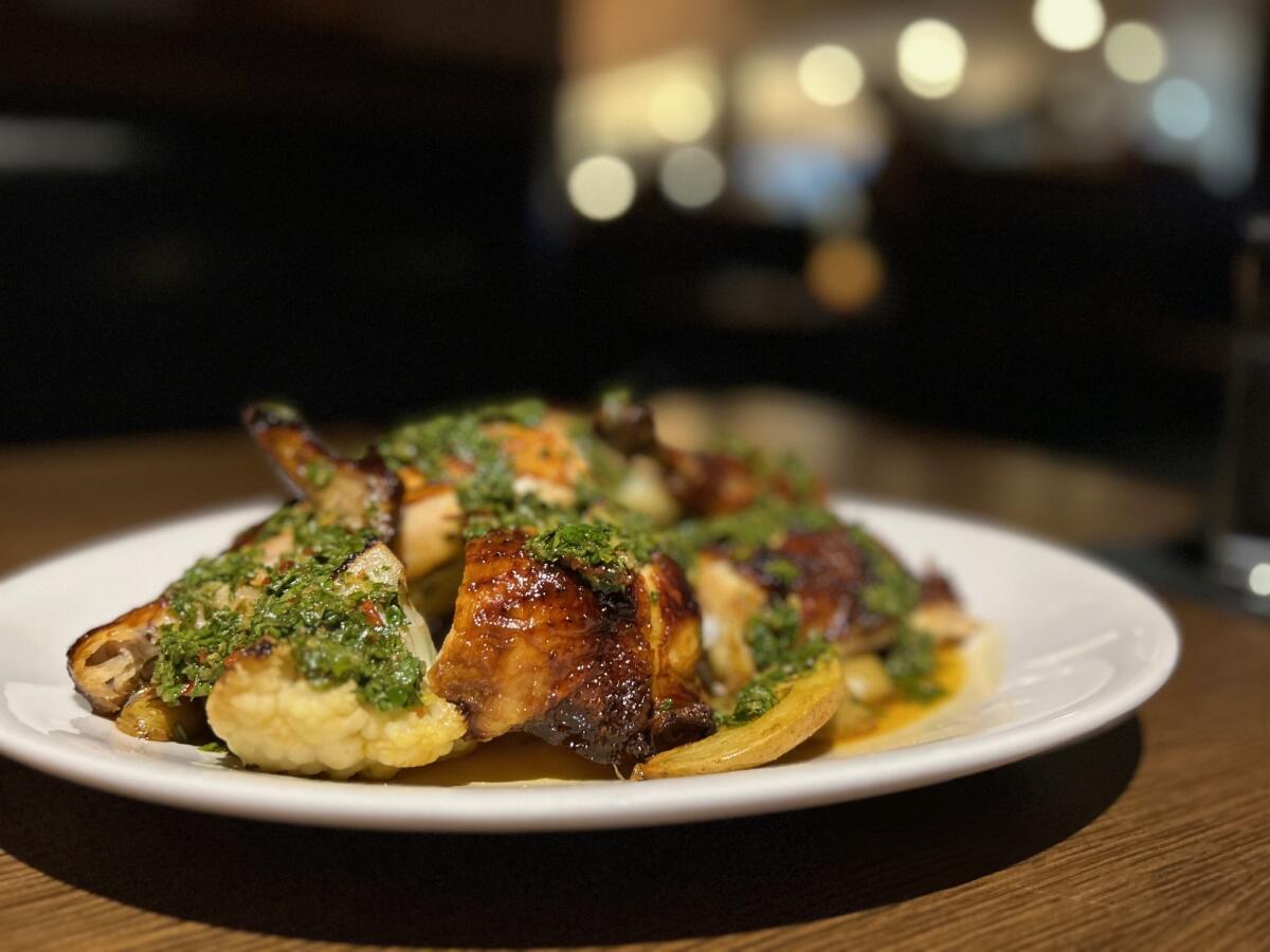 Parlor Woodfire Kitchen & Cocktails in San Clemente serves a rotisserie half chicken with roasted cauliflower.