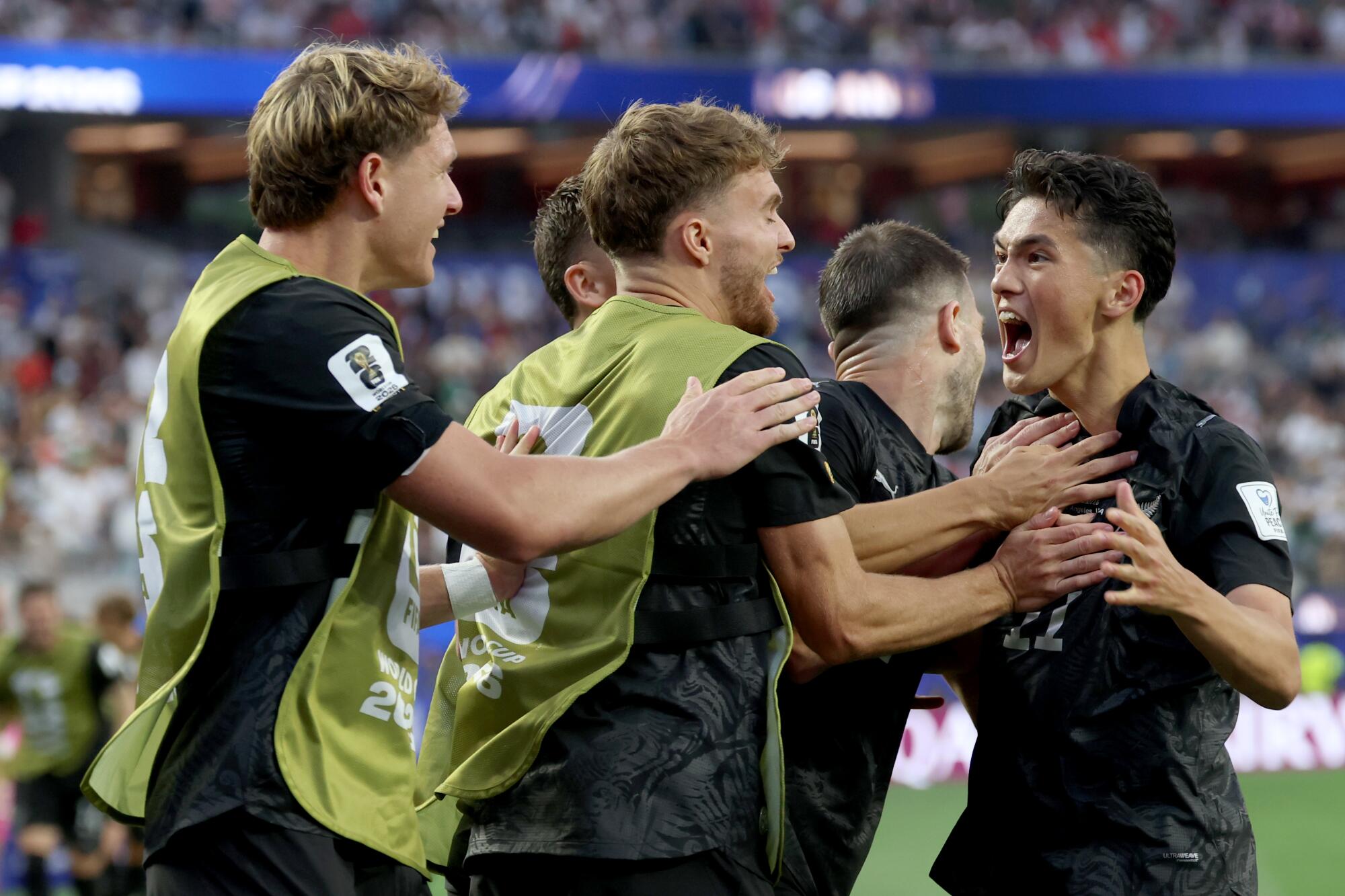 New Zealand forward Elijah Just, right, celebrates after scoring his second goal against Iran on Monday.