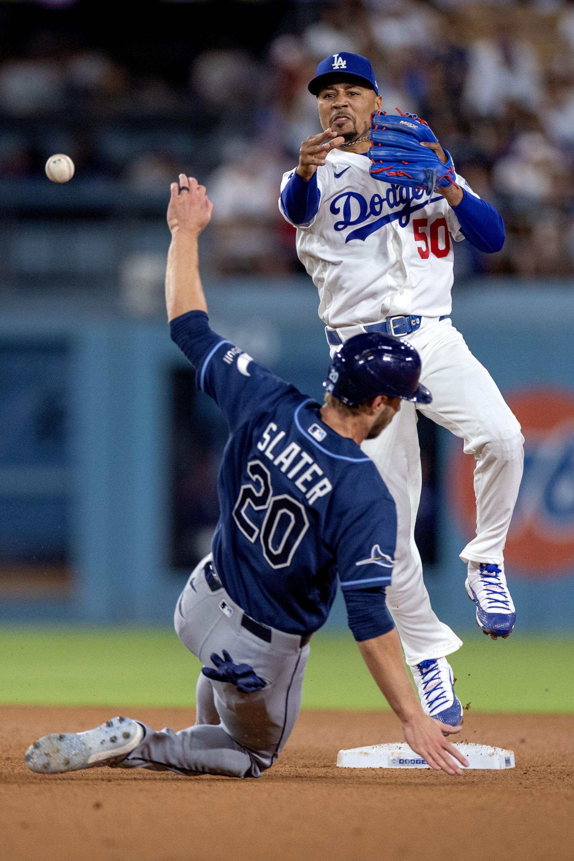 Dodgers shortstop Mookie Betts makes the throw to first base after forcing out Tampa Bay Rays right fielder Austin Slater.