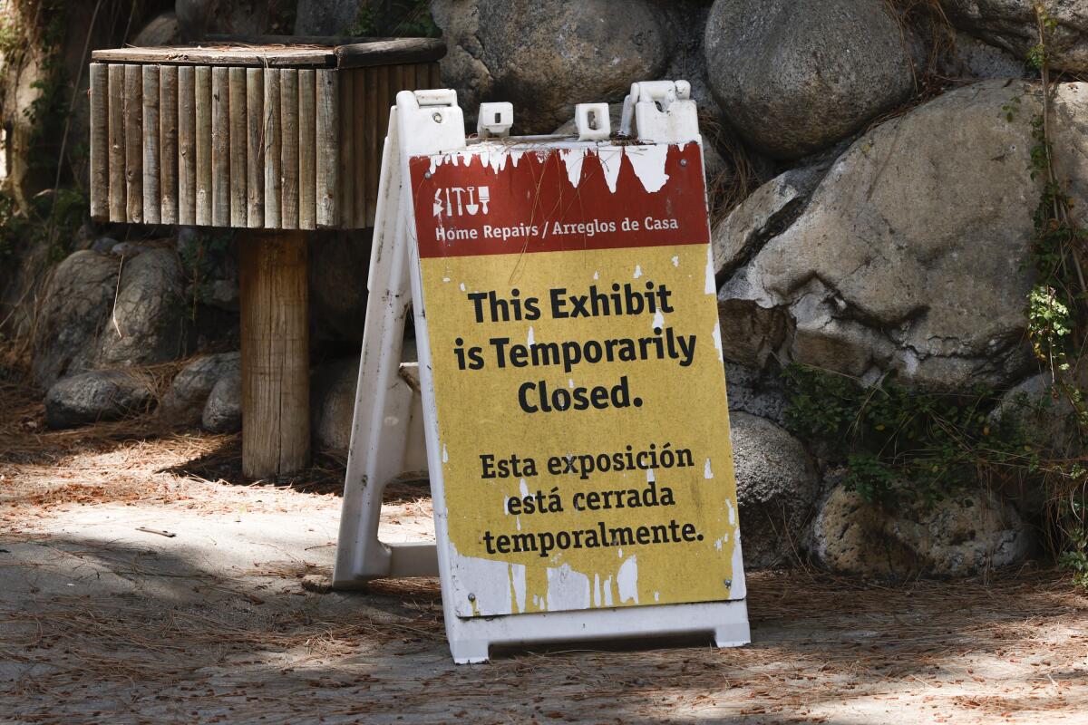 A sign displaying a closed exhibit is posted in an animal enclosure at the Los Angeles Zoo on June 27.