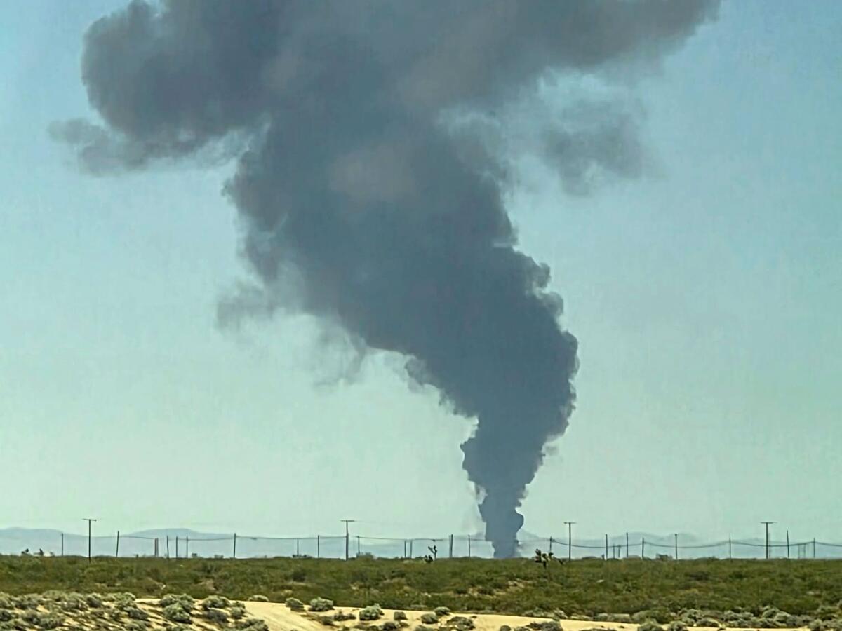 A plume of smoke rises from a B-52 bomber that crashed shortly after takeoff from Edwards Air Force Base on Monday. 
