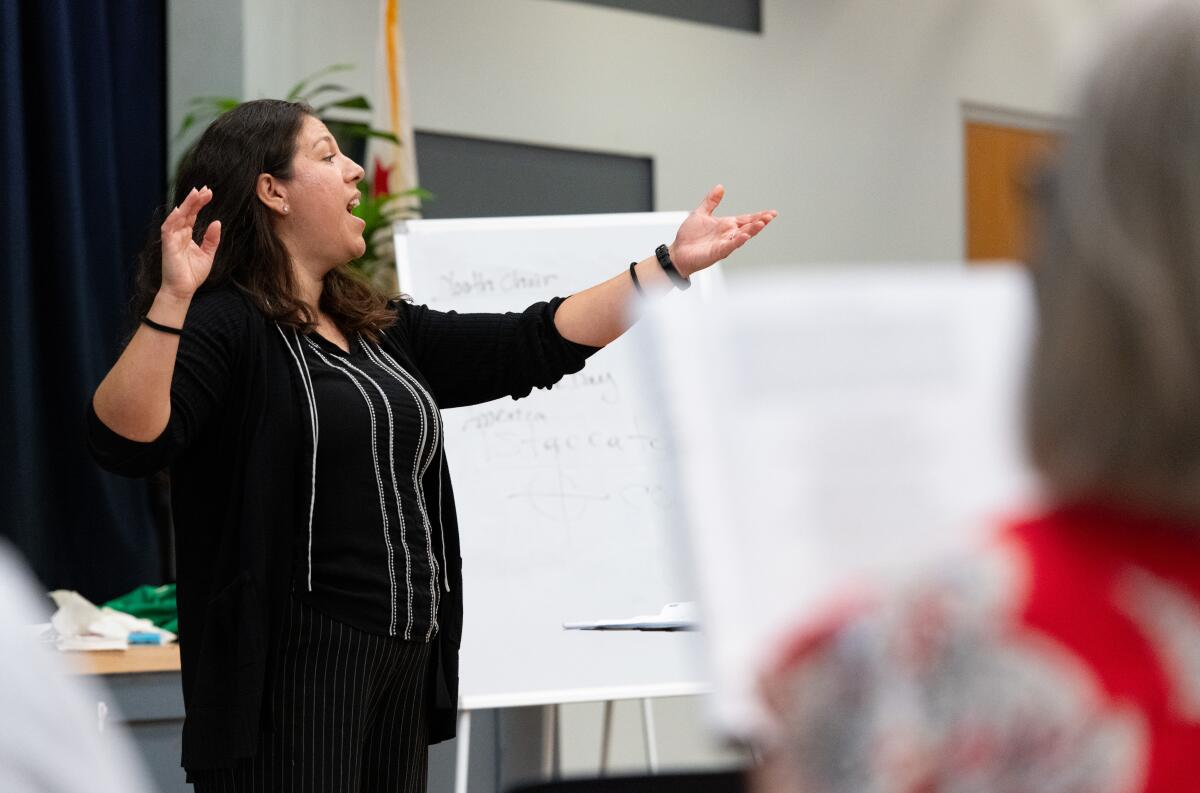 TeWinkle Middle School choir teacher Stacy Neacato leads the Voices in Unity: America 250 Choir during rehearsal.