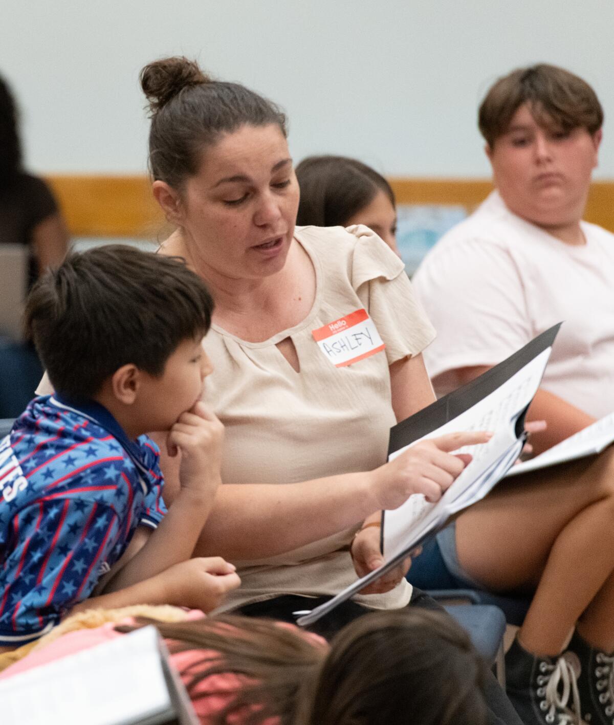 Costa Mesa High School choir conductor Ashley Riopka guides children during rehearsal on Tuesday,