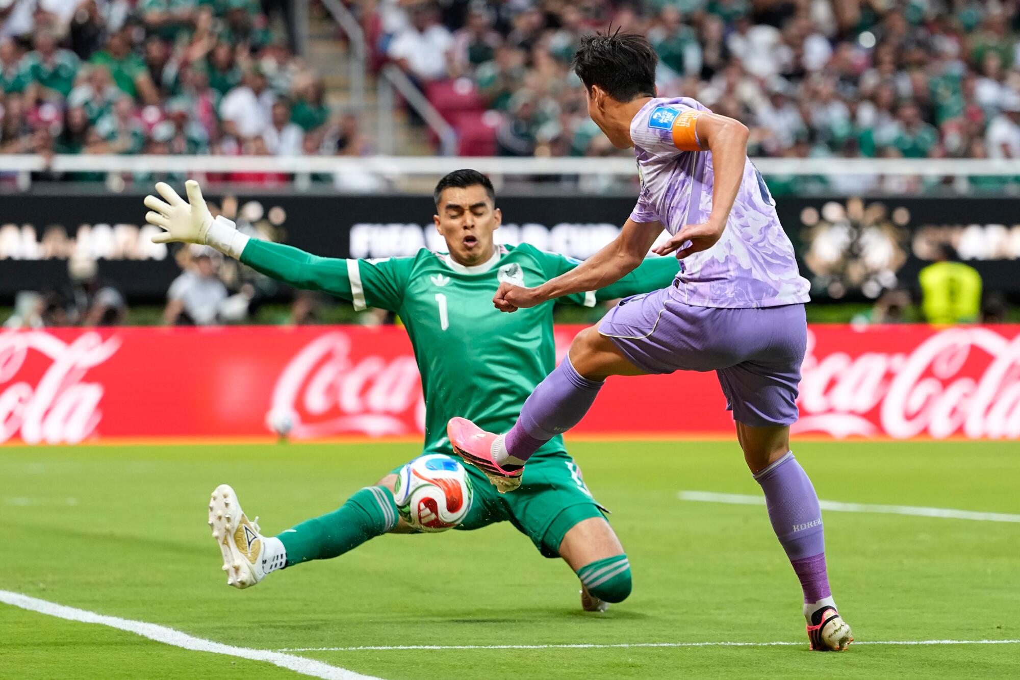 Mexico goalkeeper Raúl Rangel blocks a shot from South Korea's Son Heung-min during their World Cup match.