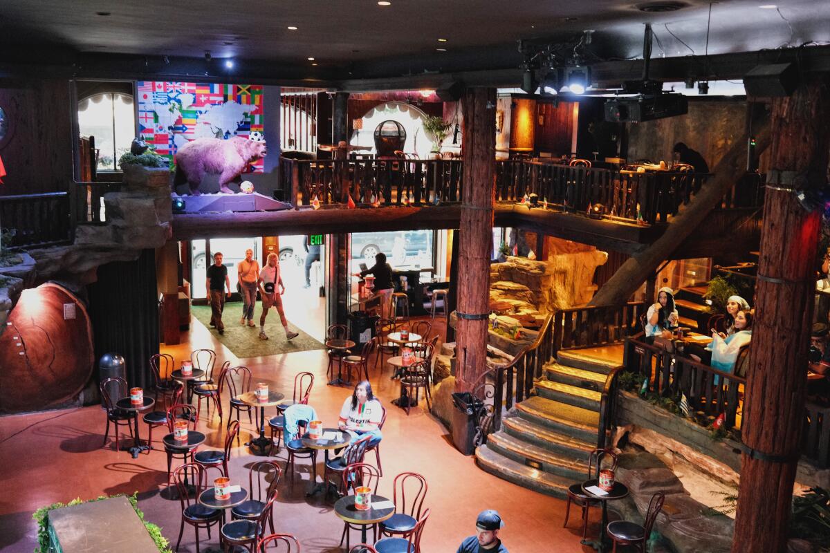 Guests seated around the entry dining room of Clifton's gather for a soccer viewing party