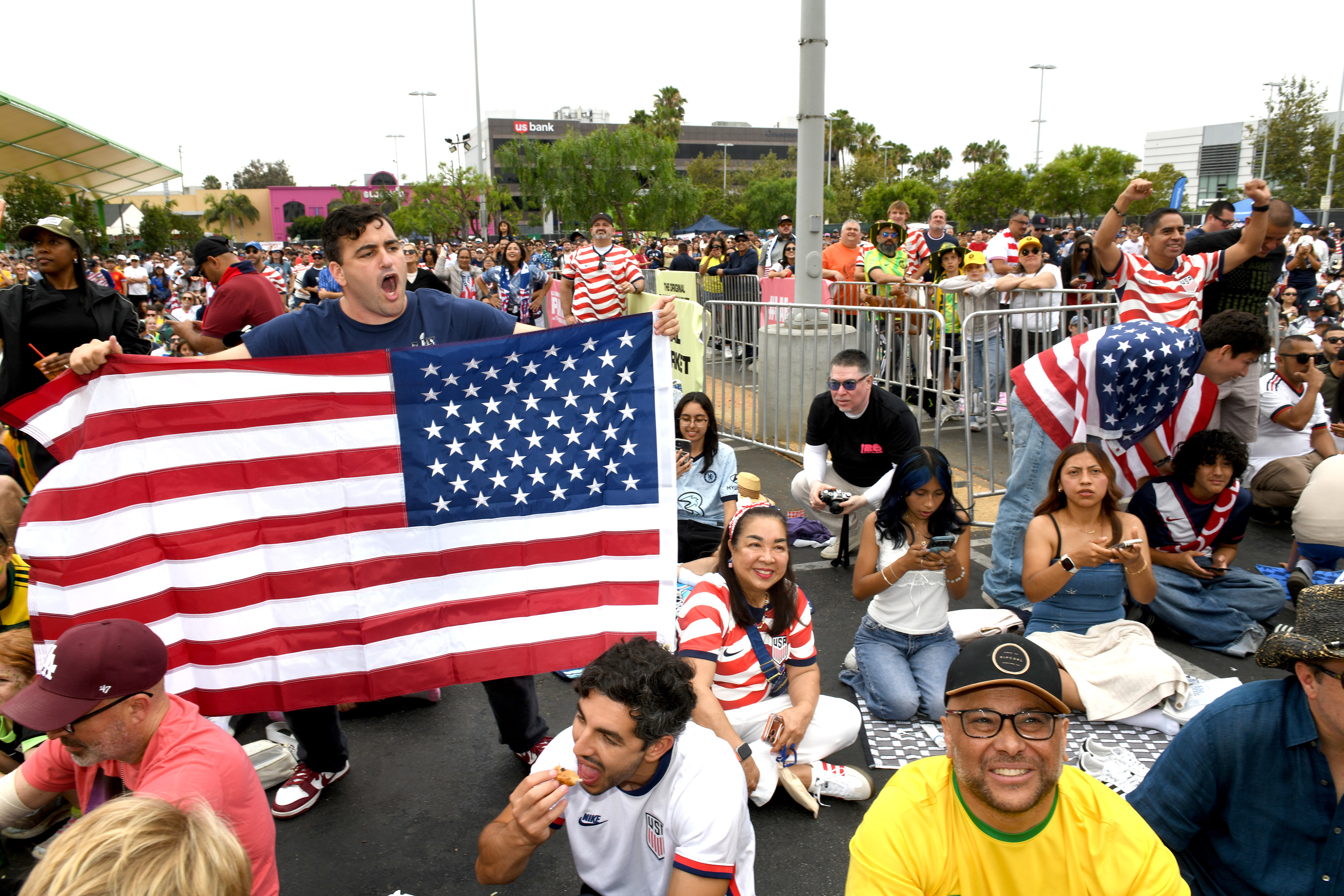 Soccer fans cheer their team as the US takes on...
