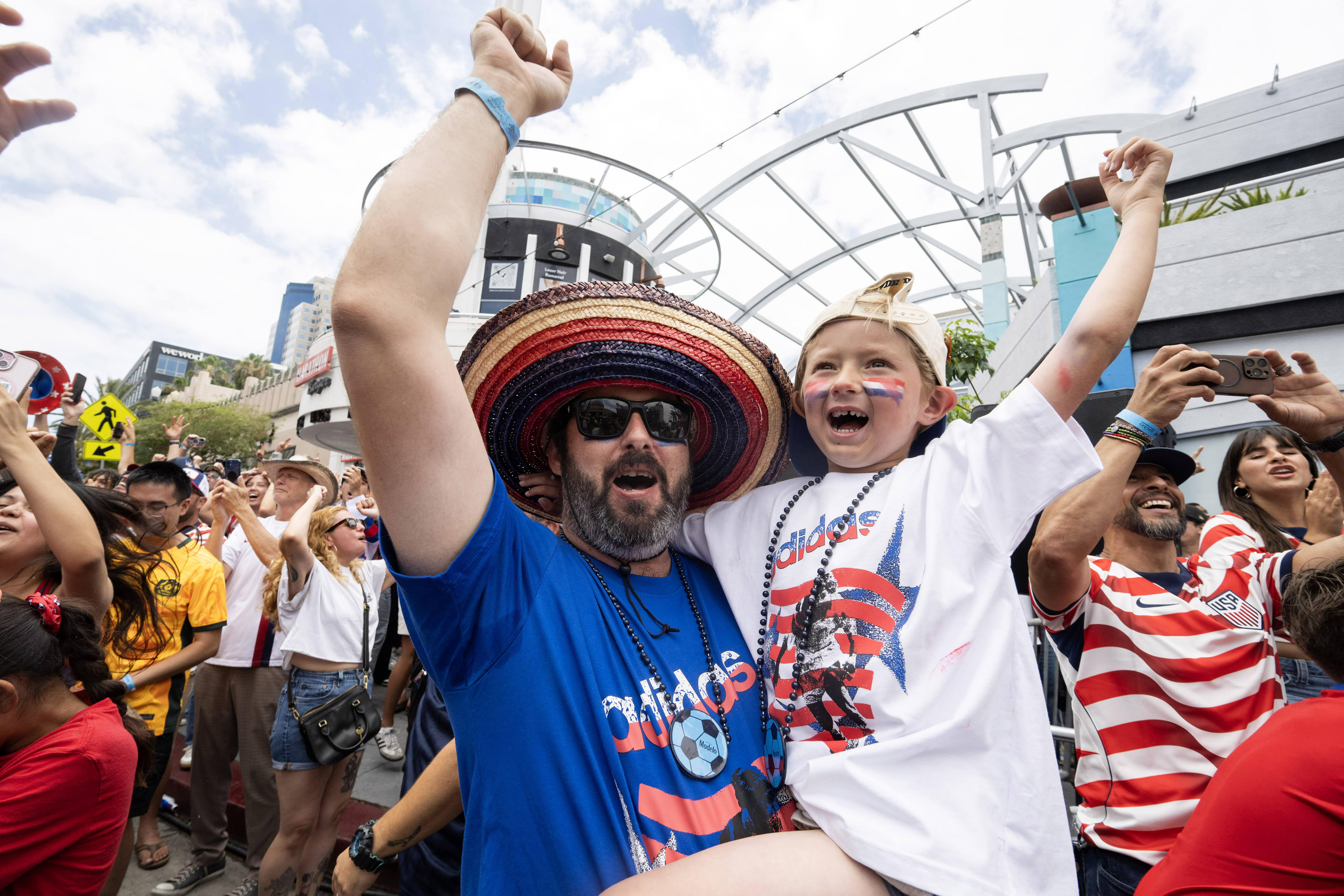 From left, Anthony Falcon and five-year-old Arrow Falcon celebrate U.S.A.âs...