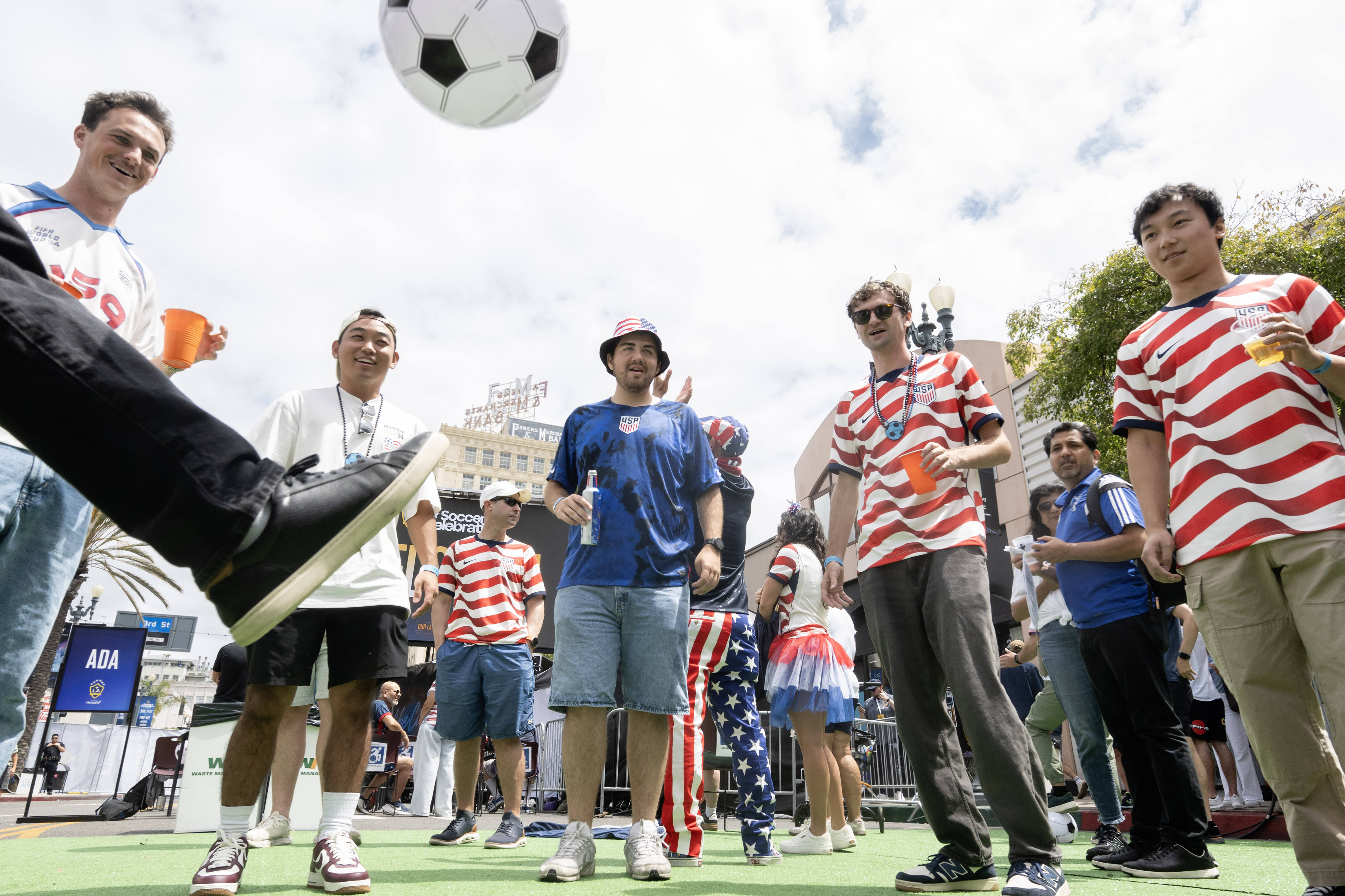 U.S.A. soccer fans kick an inflatable soccer ball during a...
