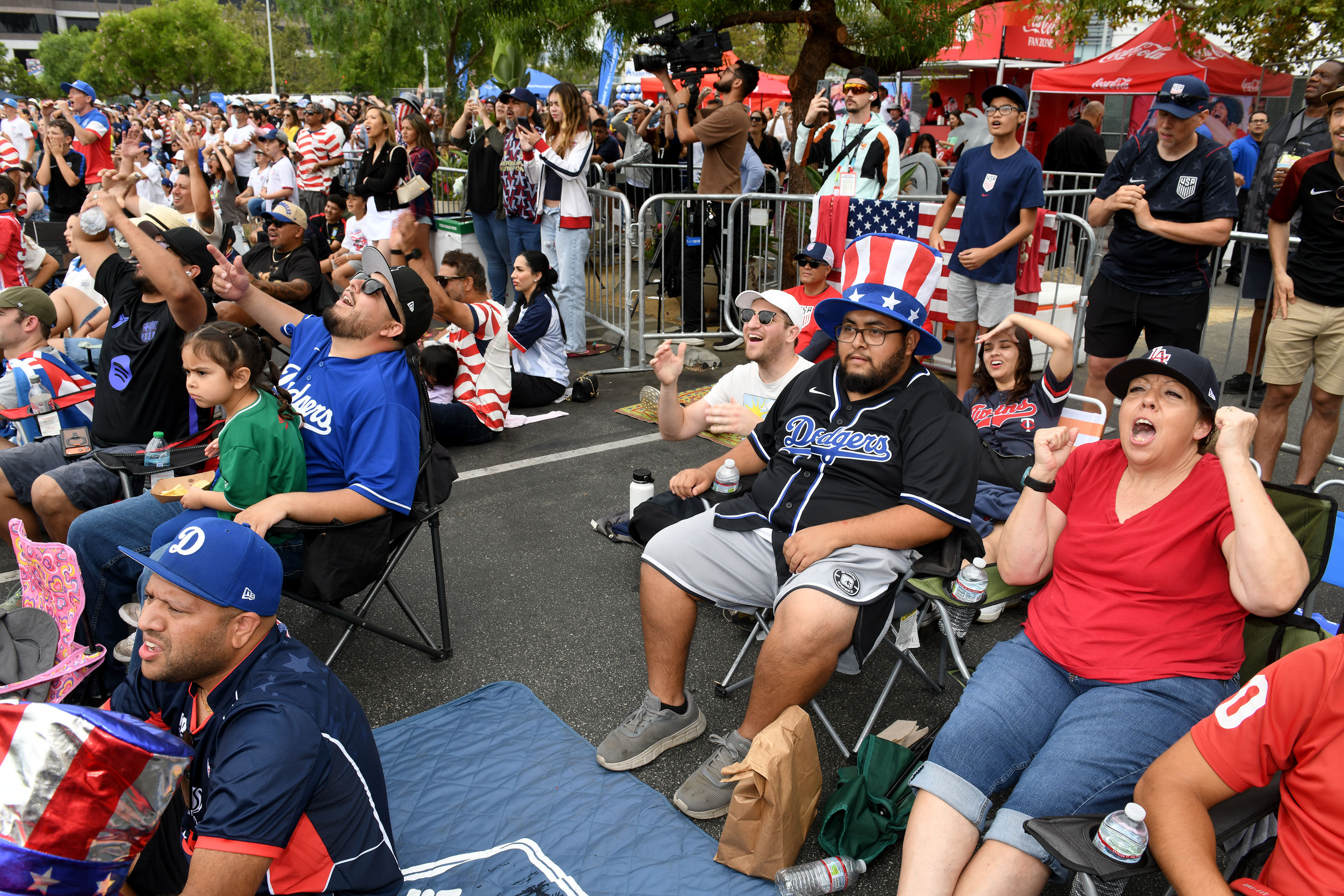 Soccer fans cheer their team as the US takes on...
