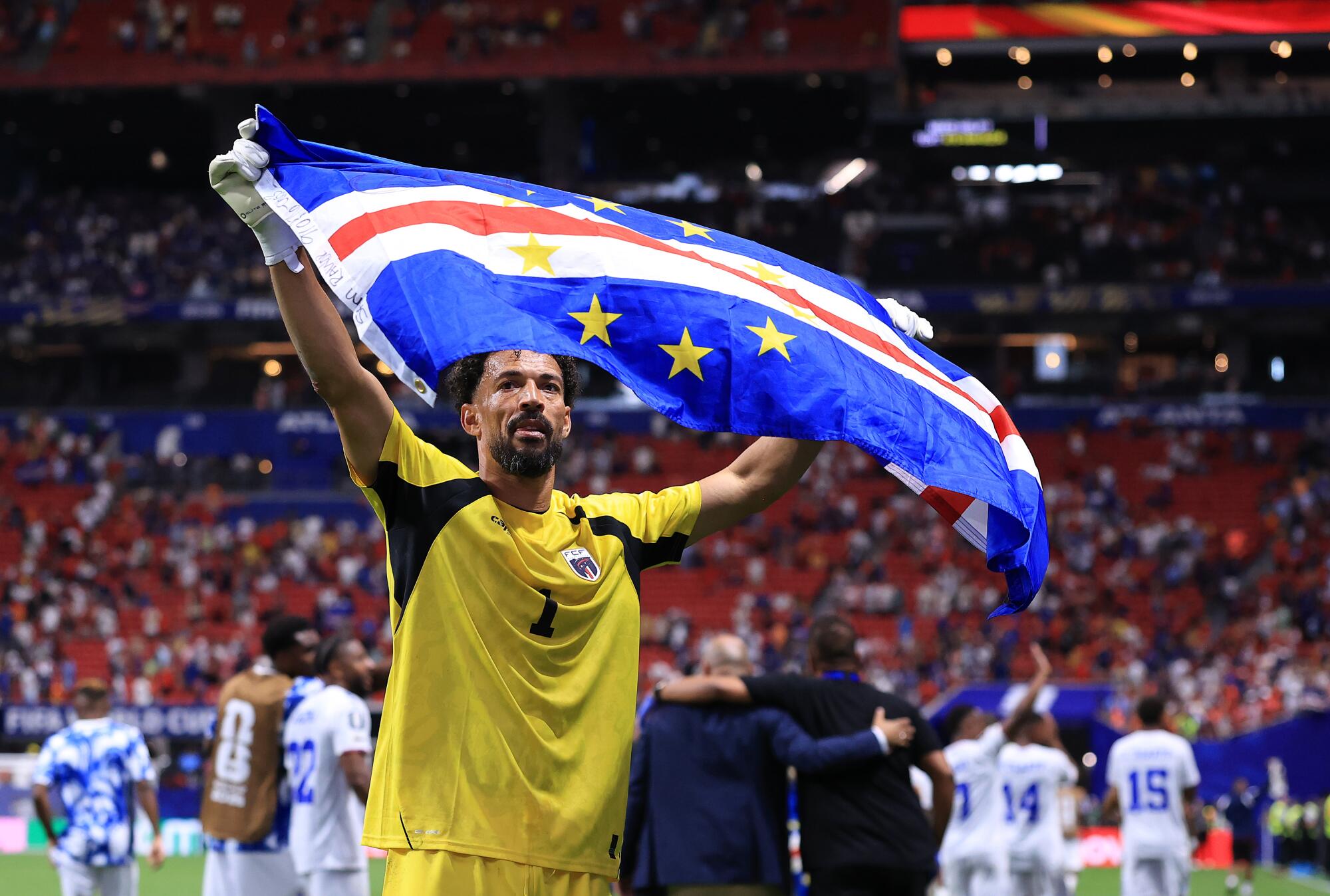 Cape Verde goalkeeper Vozinha holds the nation's flag after a draw with Spain on June 15.