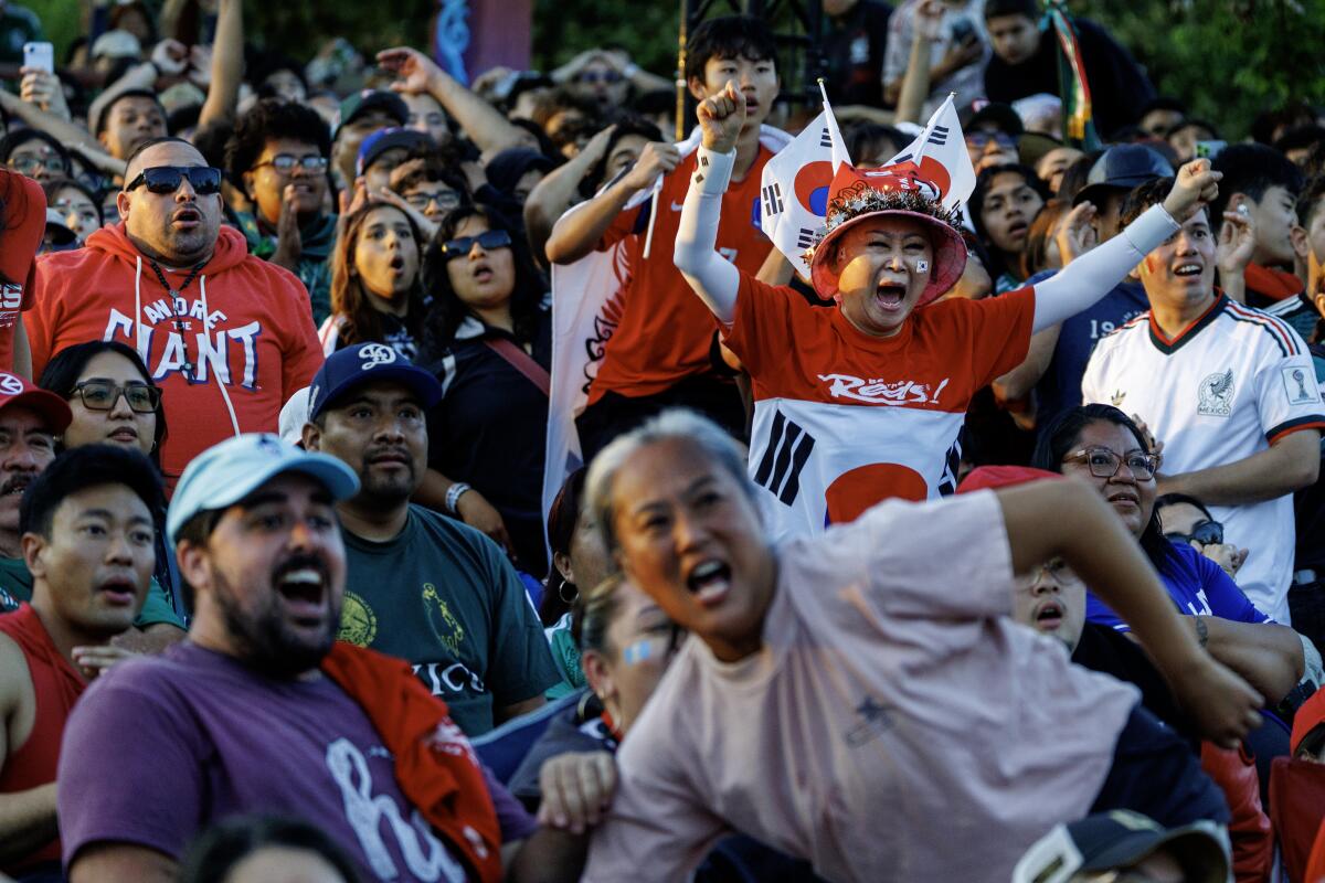 Korea and Mexico fans react as Korea almost scores against Mexico during a watch party