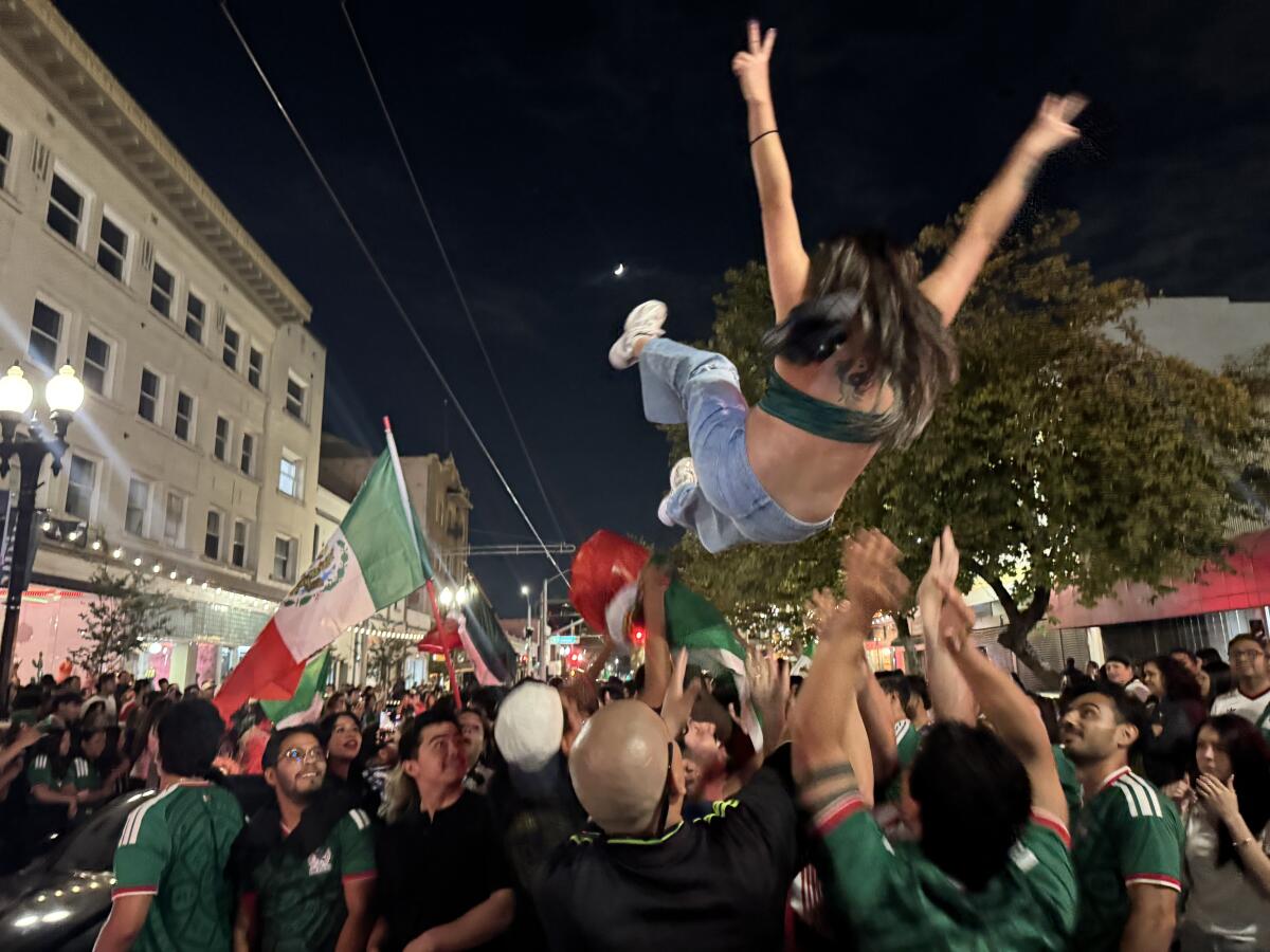 A woman gets thrown up in the air