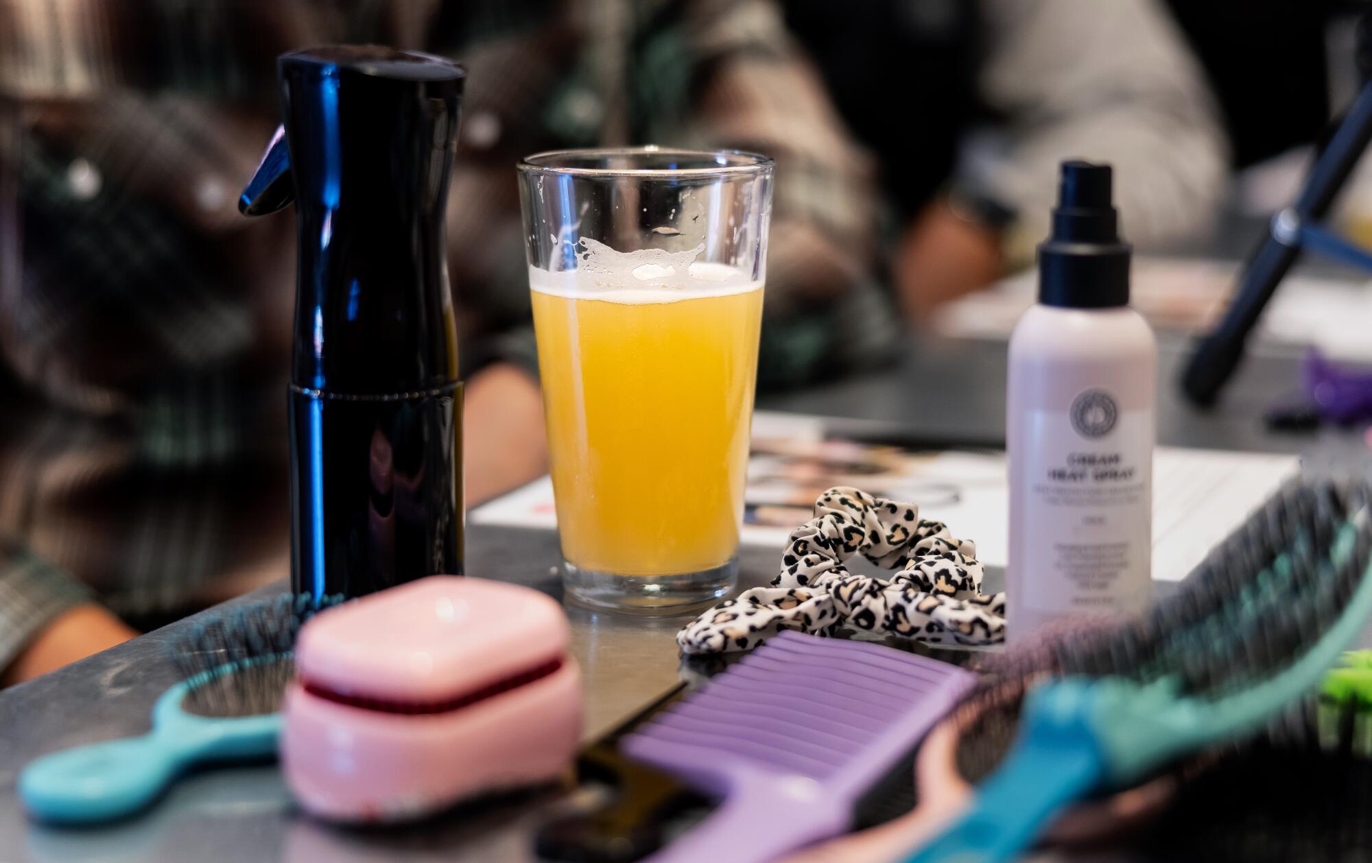 A pint sits among hairstyling tools.