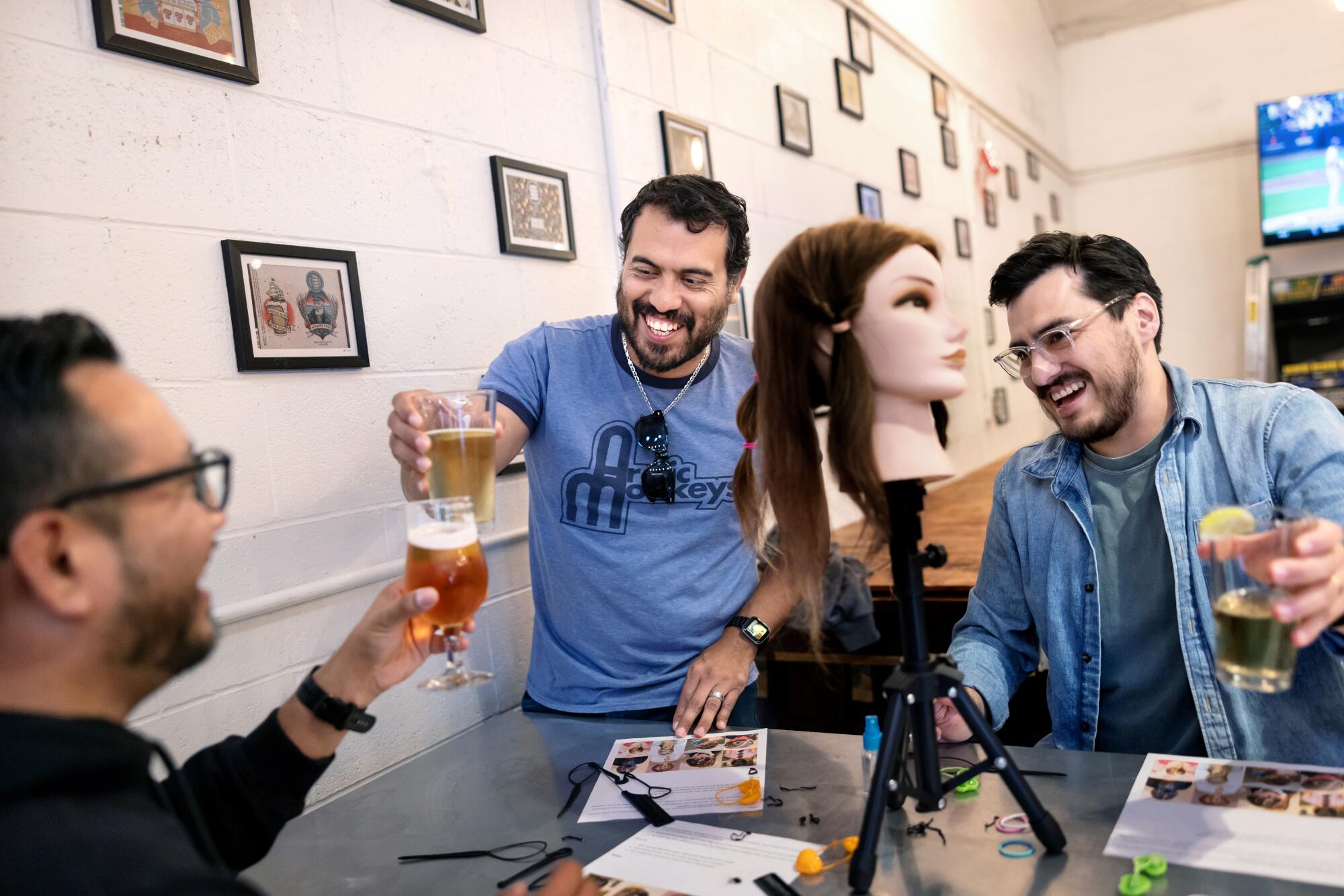 Dads cheers one another while attending a Santa Barbara Dads Group event called "Pints & Ponytails."