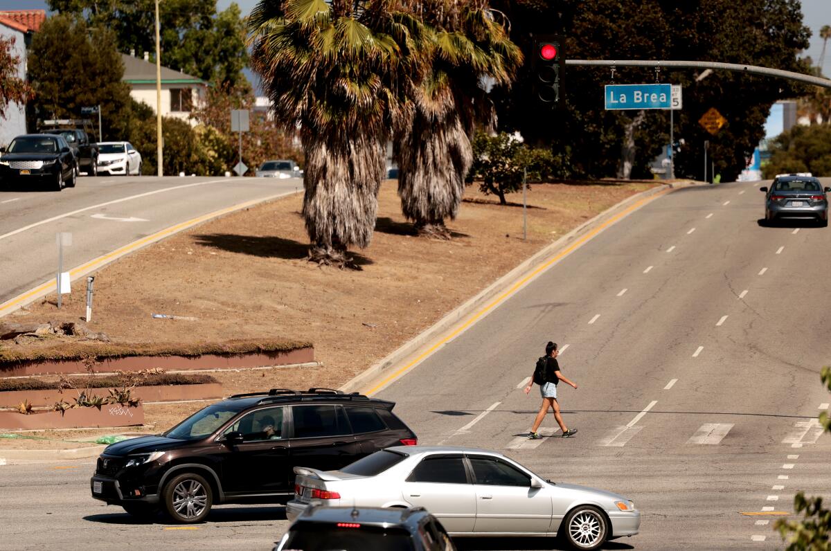 Traffic passes through the intersection of San Vicente Boulevard and La Brea.