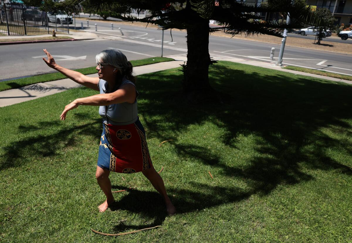 Blanca Vanburian practices tai chi in her yard along San Vicente Boulevard