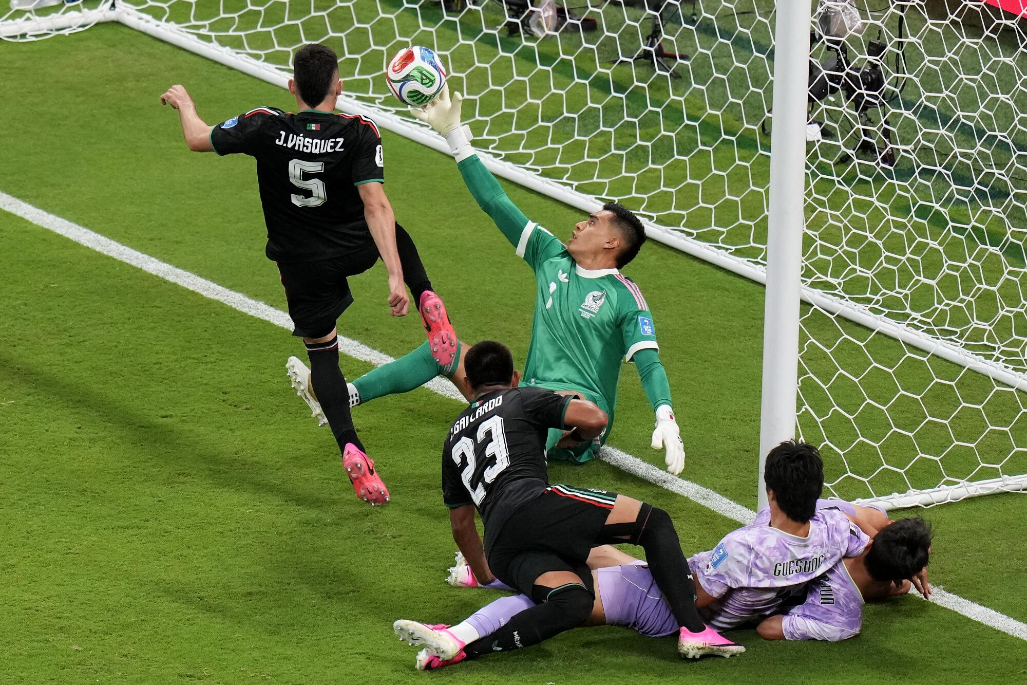 Mexico goalkeeper Raul Rangel reaches back to stop the ball from entering his goal during his team's 1-0 World Cup win.